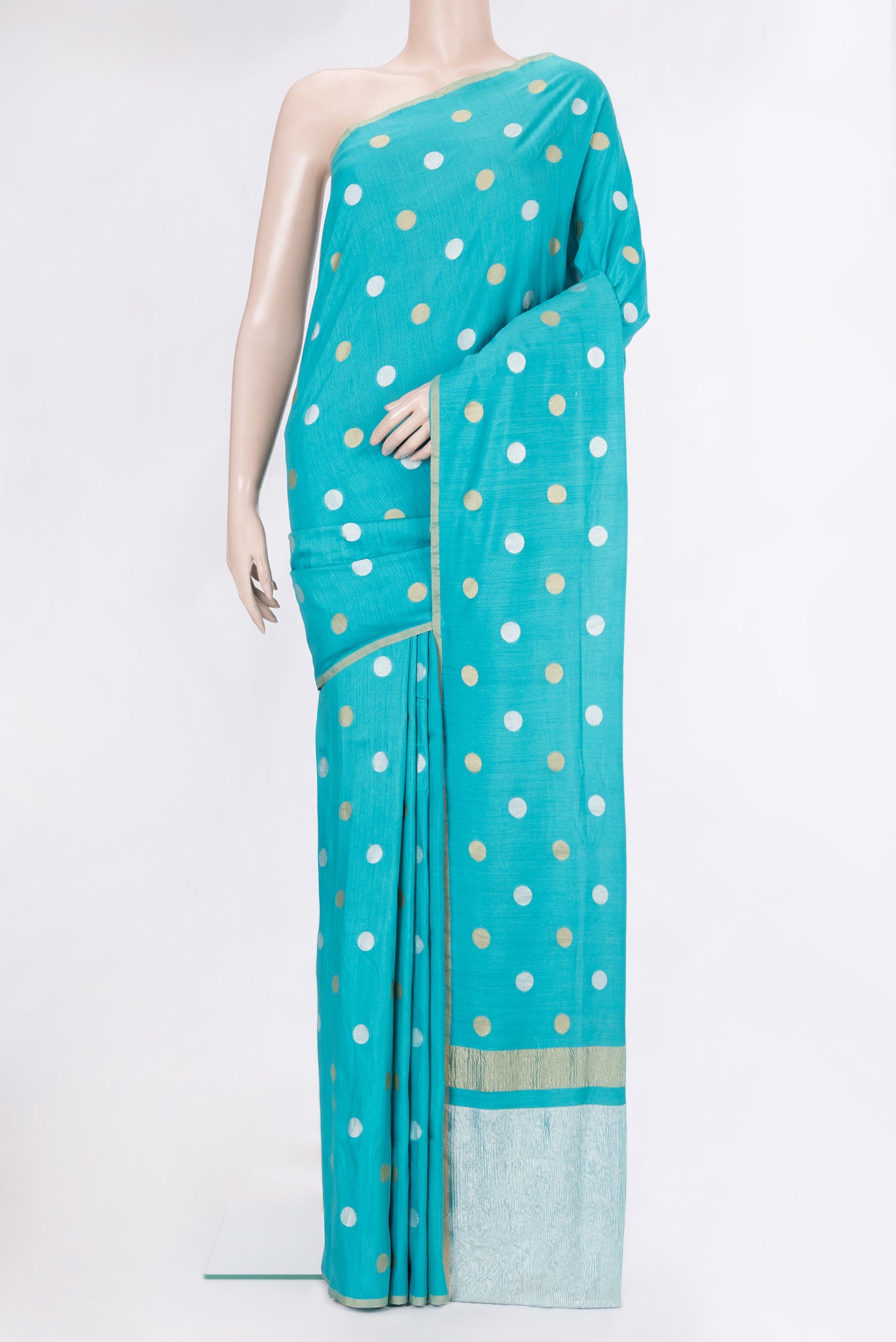 Sky Blue Tussar Silk Saree with Polka Dots on the body and Zari Border.  displayed on a mannequin