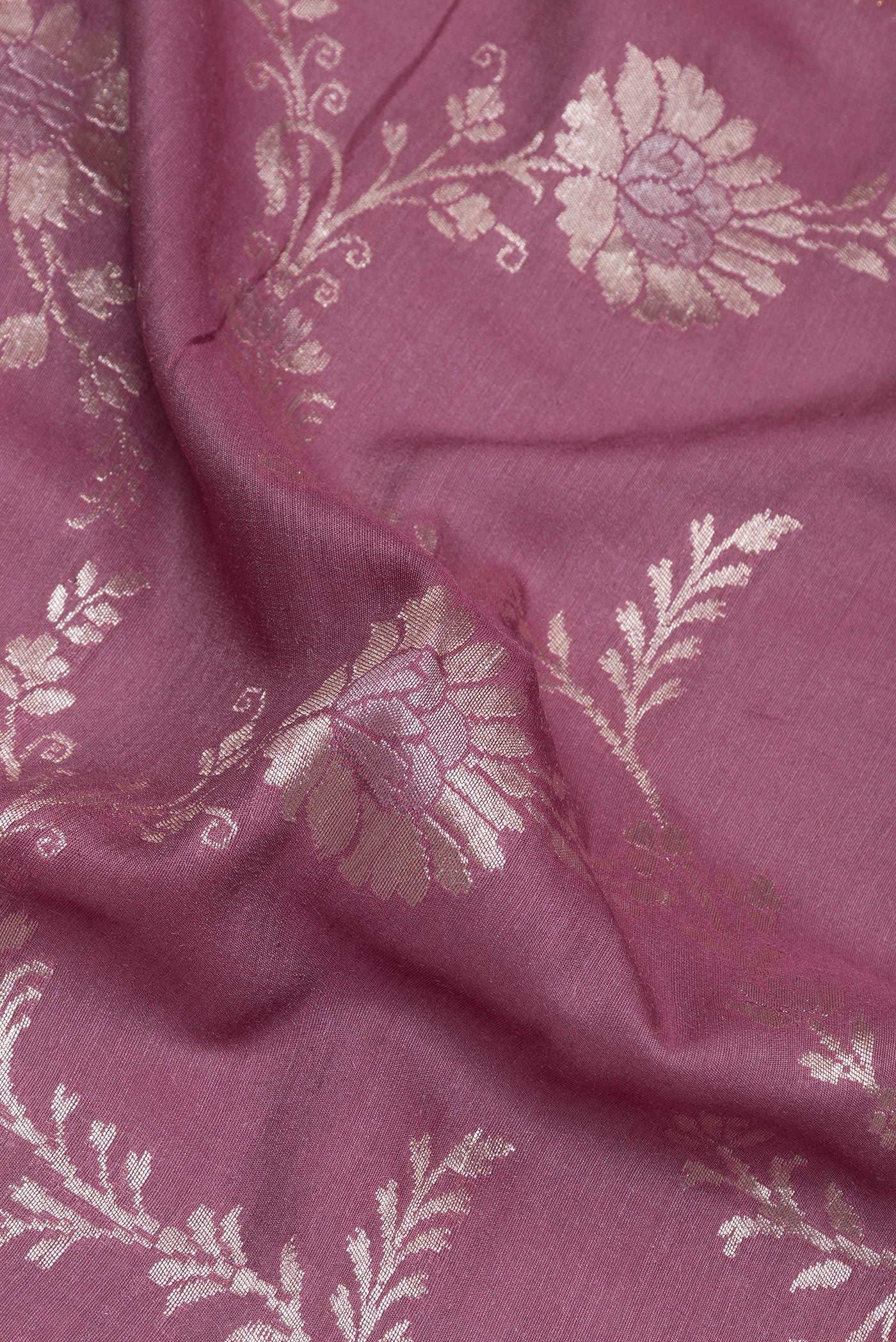 Close up of Purple Banarasi Tussar Georgette Saree with Zari Brocade on the body and Zari Border.  displaying folds