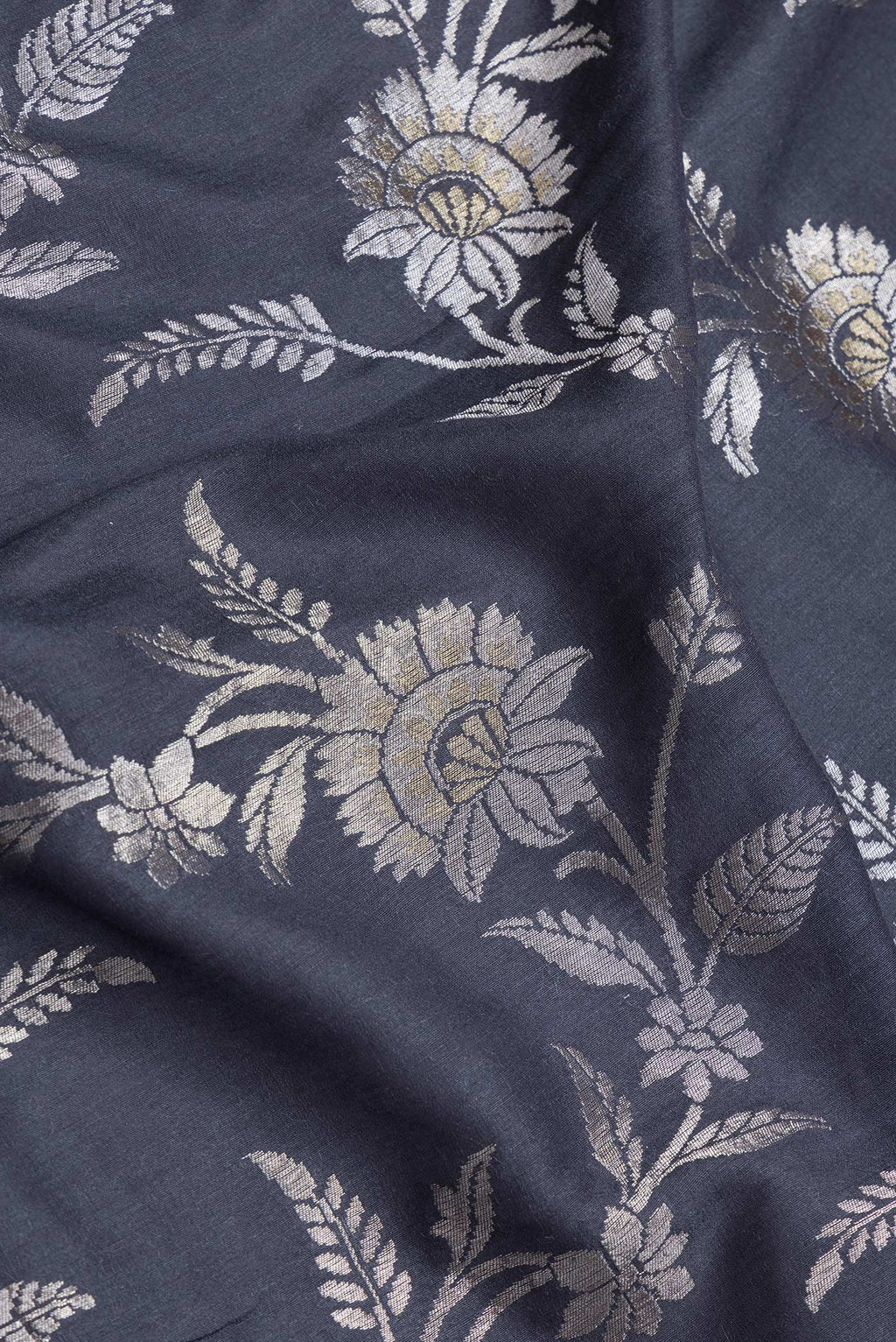Close up of Grey Dual Tone Tussar Silk Saree with Zari Brocade on the body and Zari Border.  displaying folds