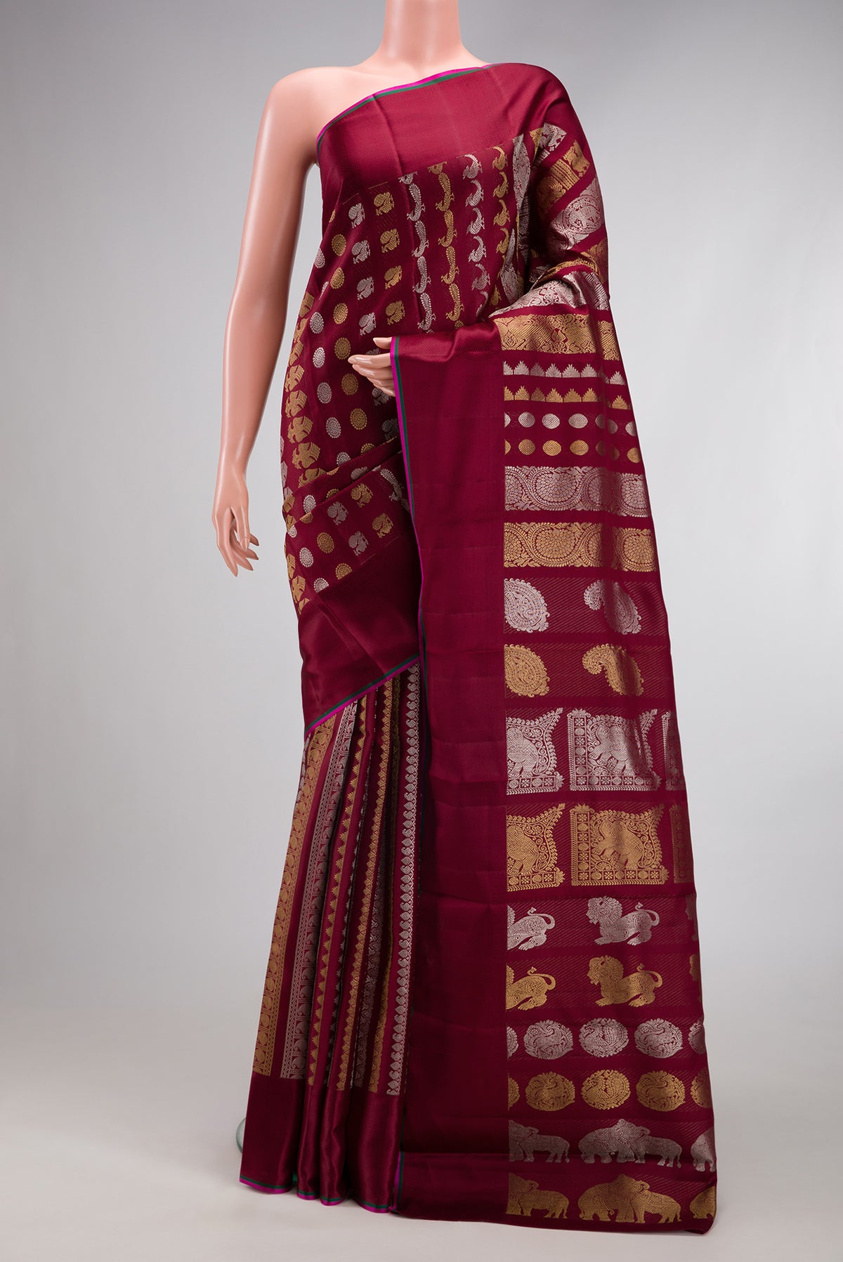 Maroon Kanchipuram Silk Saree with Zari Brocade on the body and Thread Border.  displayed on a mannequin