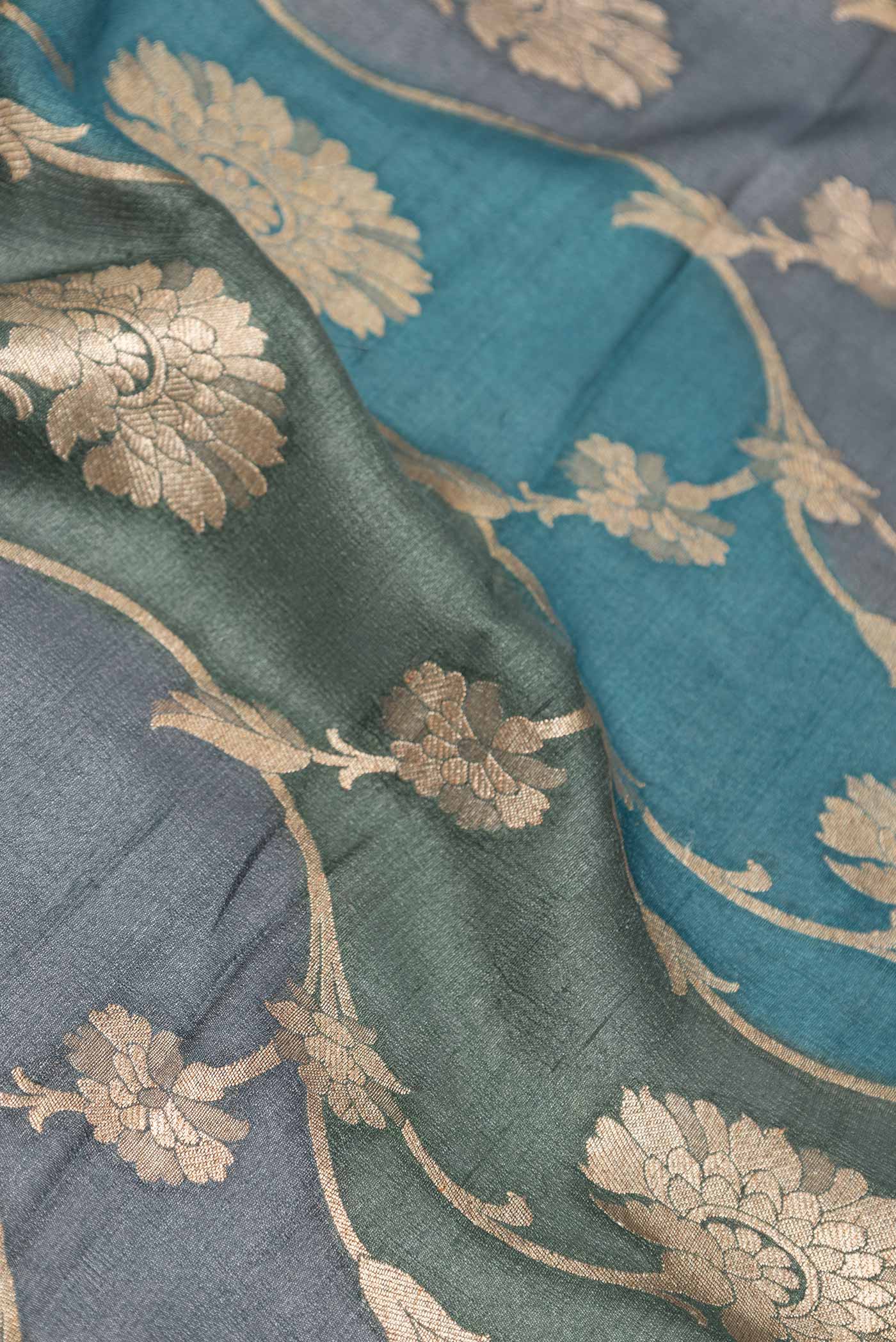 Close up of Peacock Blue Dual Tone Banarasi Georgette Saree with Zari Brocade on the body and Zari Border displaying folds