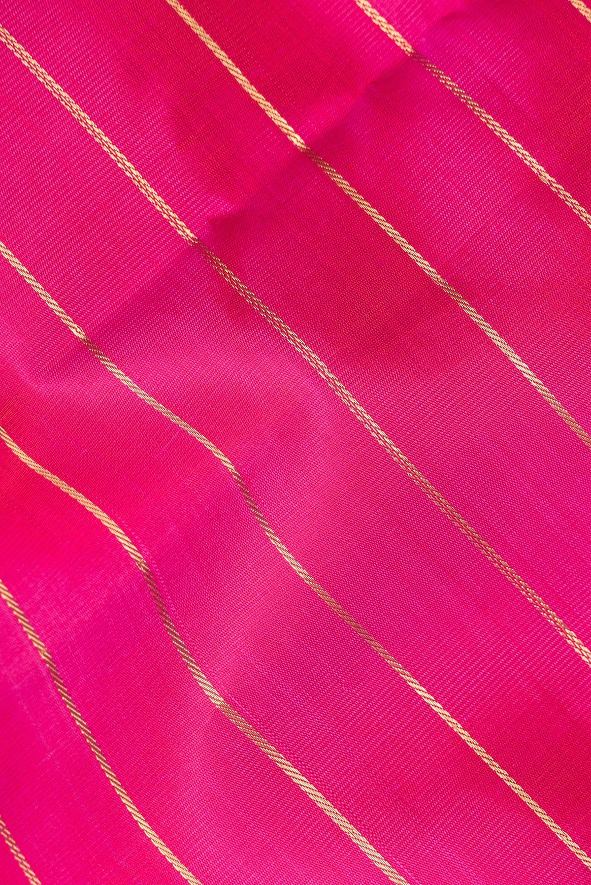 Close up of Pure Silk Dark Pink Kanjivaram Saree with Stripes on the body and Zari Border.  displaying folds