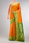 Orange Dual Tone Kanjivaram Silk Saree with Zari Butta on the body and Zari Border.  displayed on a mannequin