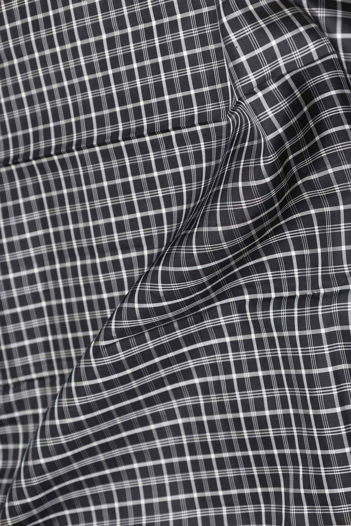Close up of Pure Silk Pure Zari Black Dual Tone Kanchipuram Saree with Checked design on the body and Zari Border displaying folds