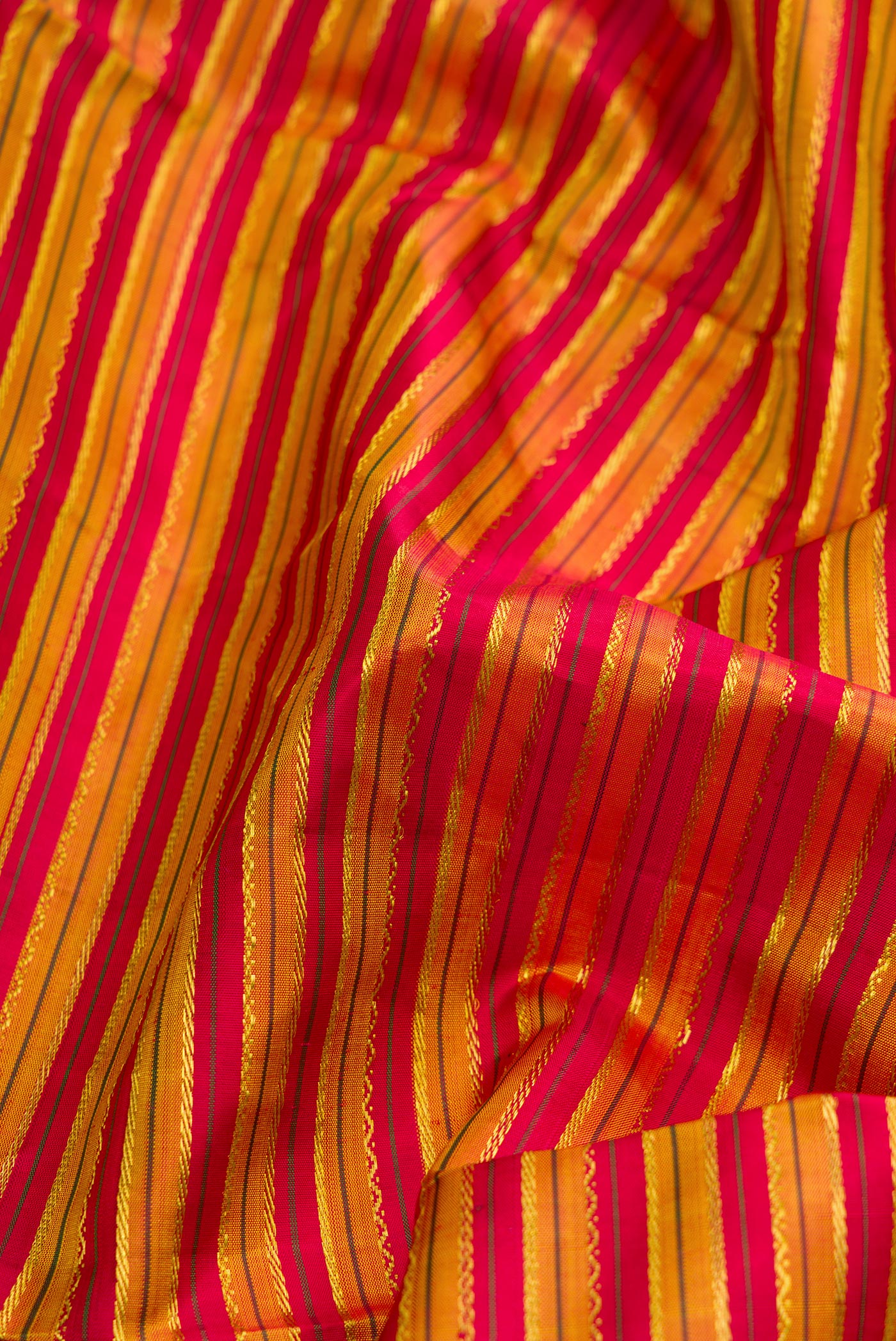 Close up of Pure Silk Pure Zari Maroon Dual Tone Kanchipuram Nine Yards Saree with Stripes on the body and Zari Border.  displaying folds