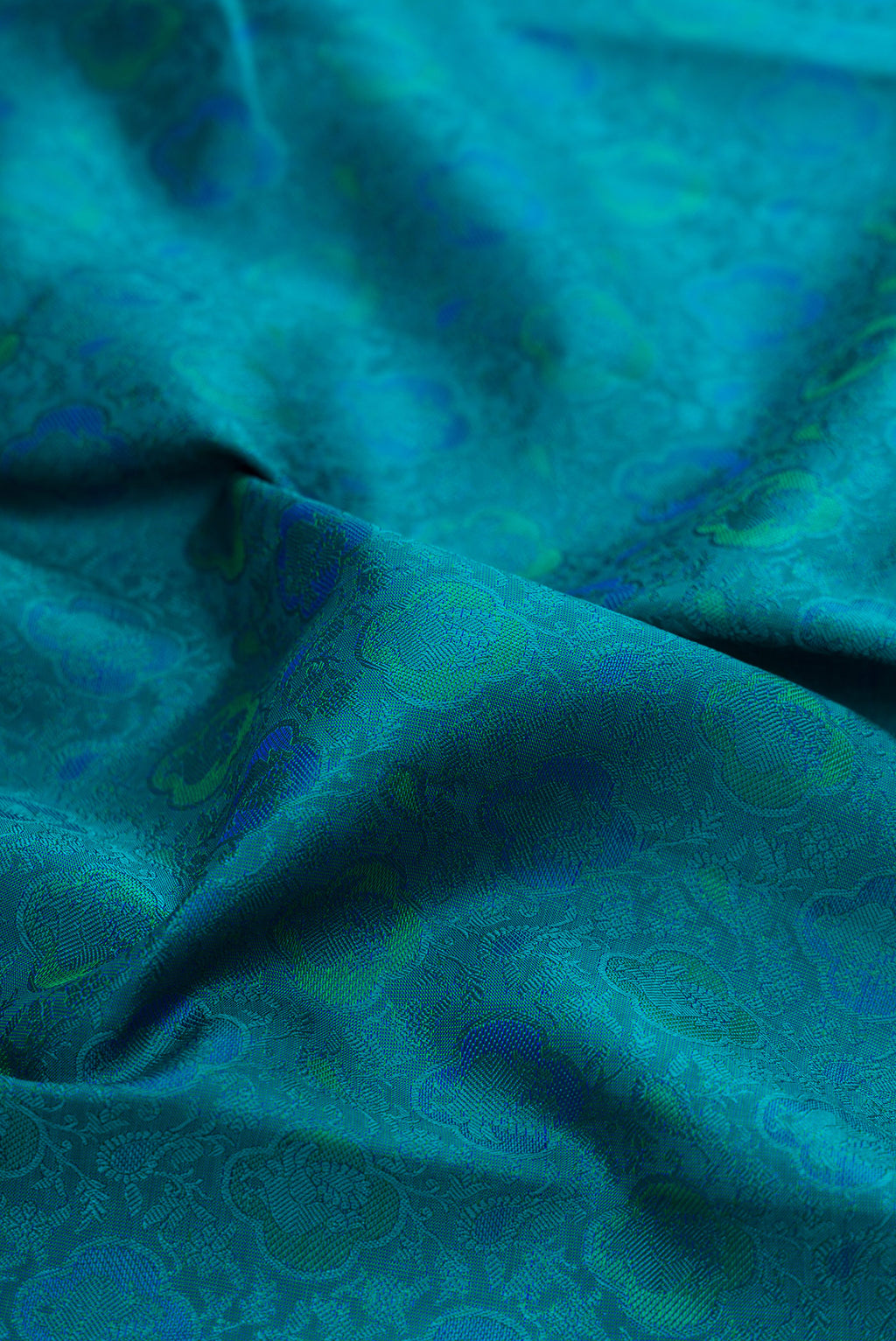 Close up of Pure Silk Pure Zari Peacock Blue Kanchipuram Saree with Jacquard design on the body and Zari Border.  displaying folds