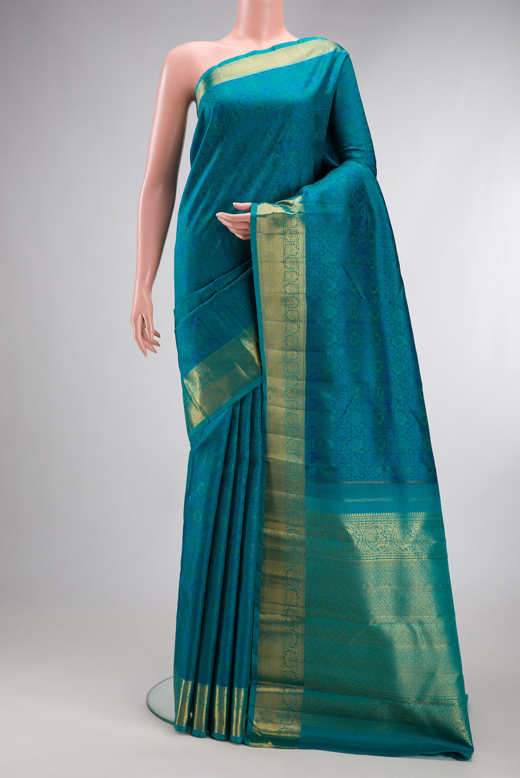 Pure Silk Pure Zari Peacock Blue Kanchipuram Saree with Jacquard design on the body and Zari Border.  displayed on a mannequin