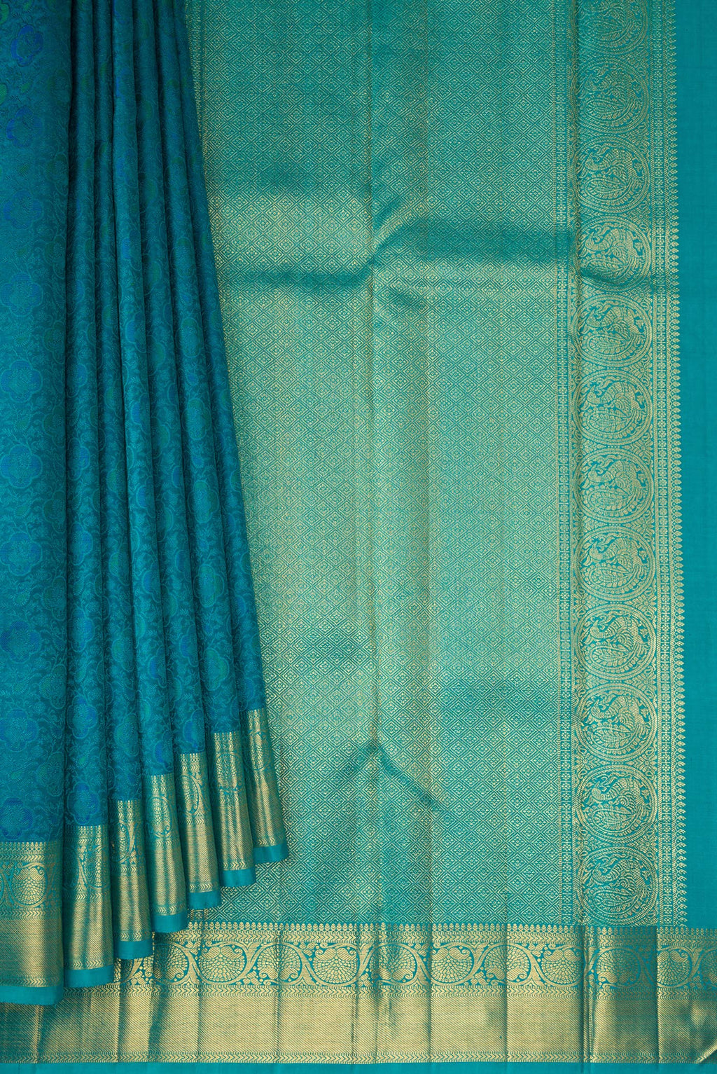 Pleats and pallu of Pure Silk Pure Zari Peacock Blue Kanchipuram Saree with Jacquard design on the body and Zari Border. 
