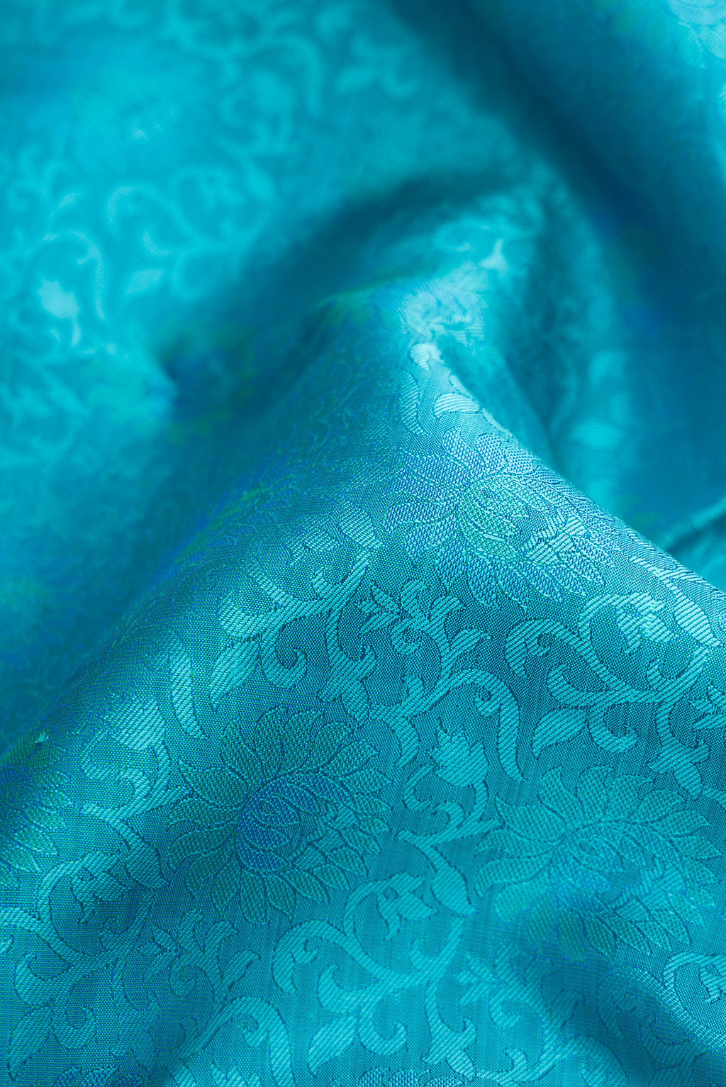 Close up of Sky Blue Dual Tone Kanchipuram Silk Saree with Jacquard design on the body and Zari Border.  displaying folds