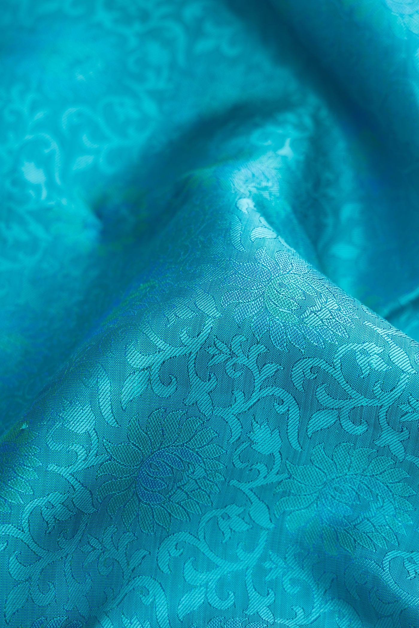 Close up of Sky Blue Dual Tone Kanchipuram Silk Saree with Jacquard design on the body and Zari Border.  displaying folds