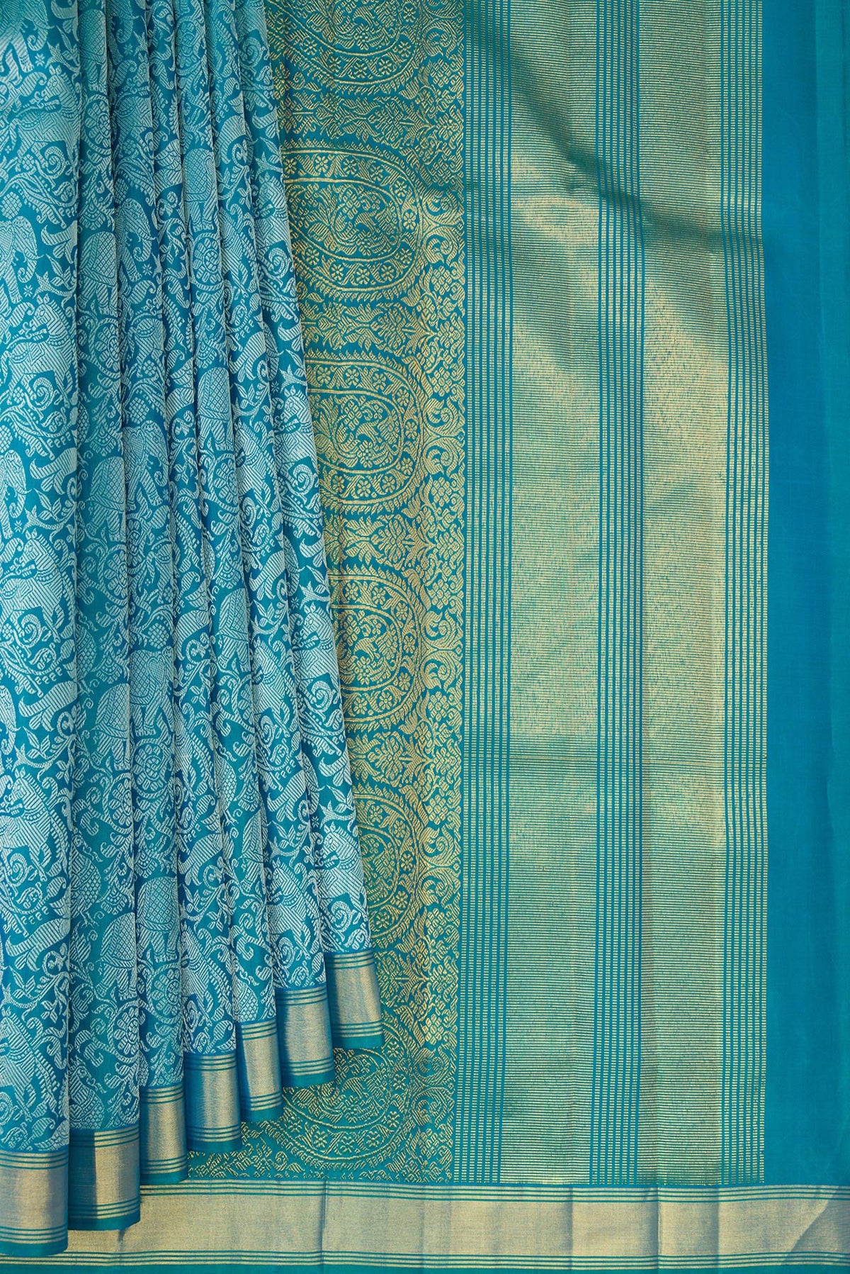 Pleats and pallu of Pure Silk Pure Zari Peacock Blue Dual Tone Kanchipuram Saree with Jacquard design on the body and Zari Border. 