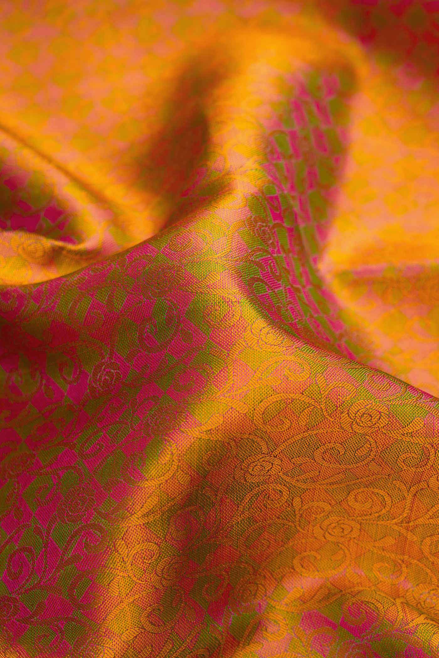 Close up of Pure Silk Pure Zari Pink Dual Tone Kanchipuram Saree with Jacquard design on the body and Zari Border.  displaying folds