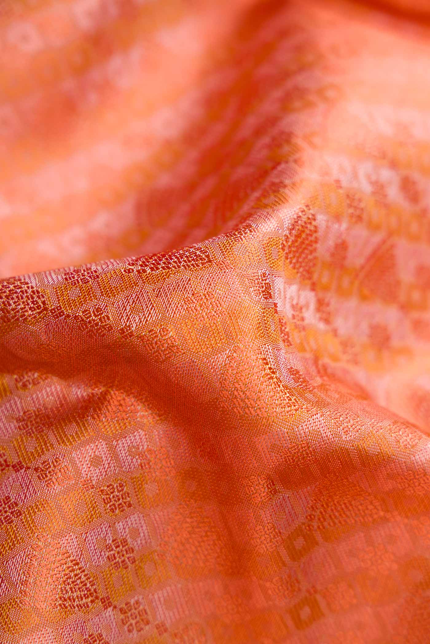 Close up of Pure Silk Pure Zari Golden Peach Dual Tone Kanchipuram Saree with Jacquard design on the body and Zari Border.  displaying folds
