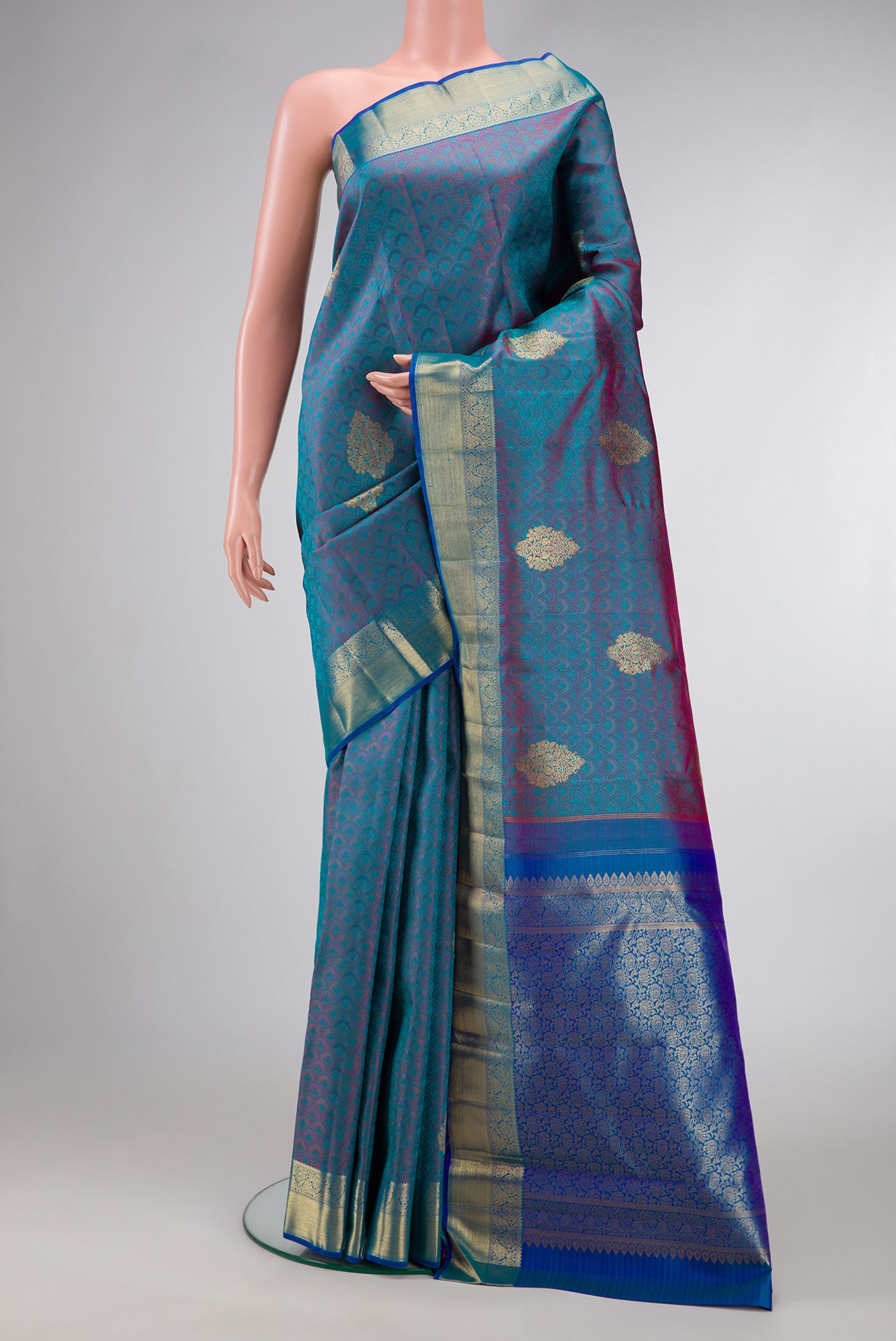 Pure Silk Pure Zari Peacock Blue Dual Tone Kanchipuram Saree with Jacquard With Zari Butta on the body and Zari Border.  displayed on a mannequin