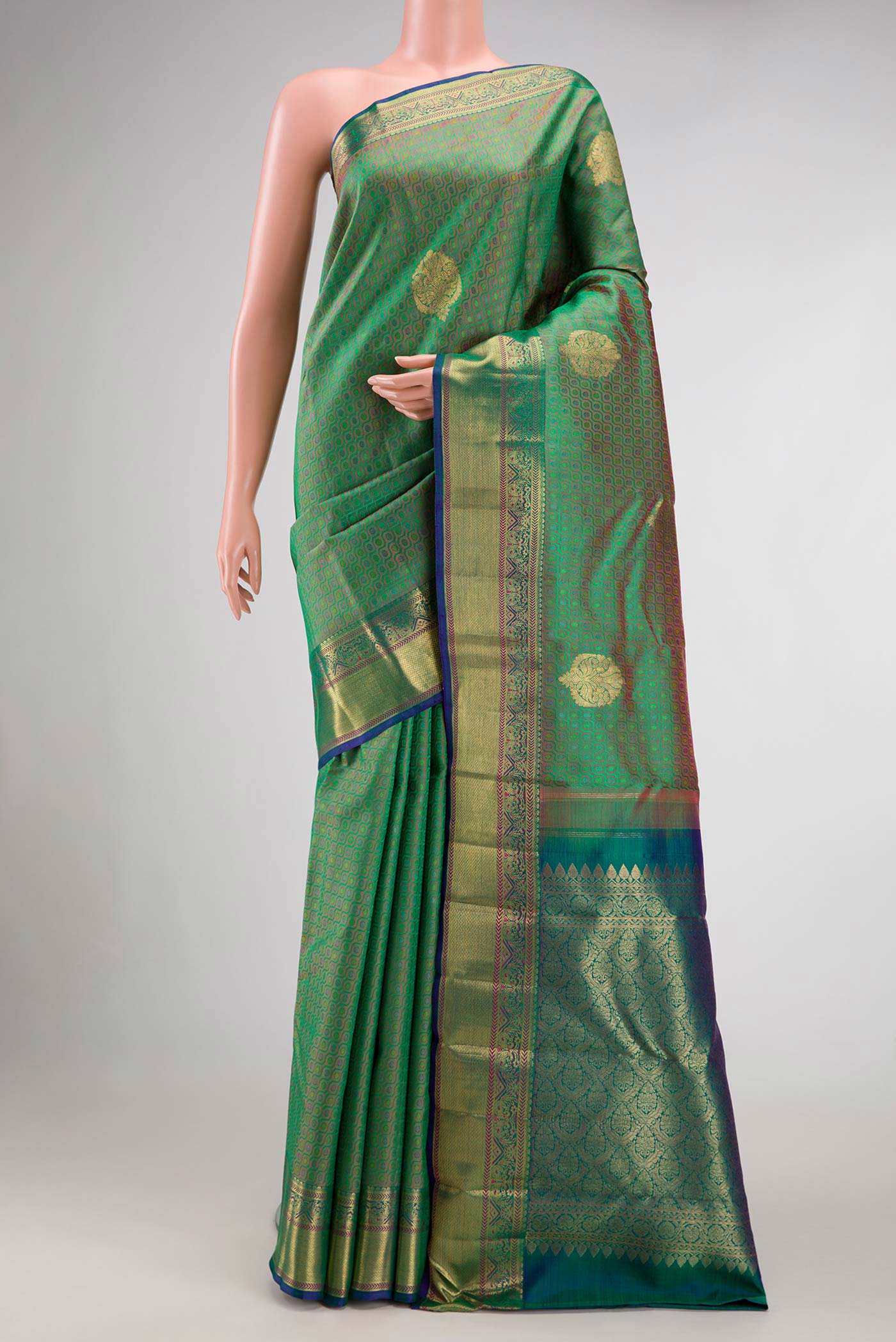 Pure Silk Pure Zari Green Dual Tone Kanchipuram Saree with Jacquard With Zari Butta on the body and Zari Border.  displayed on a mannequin