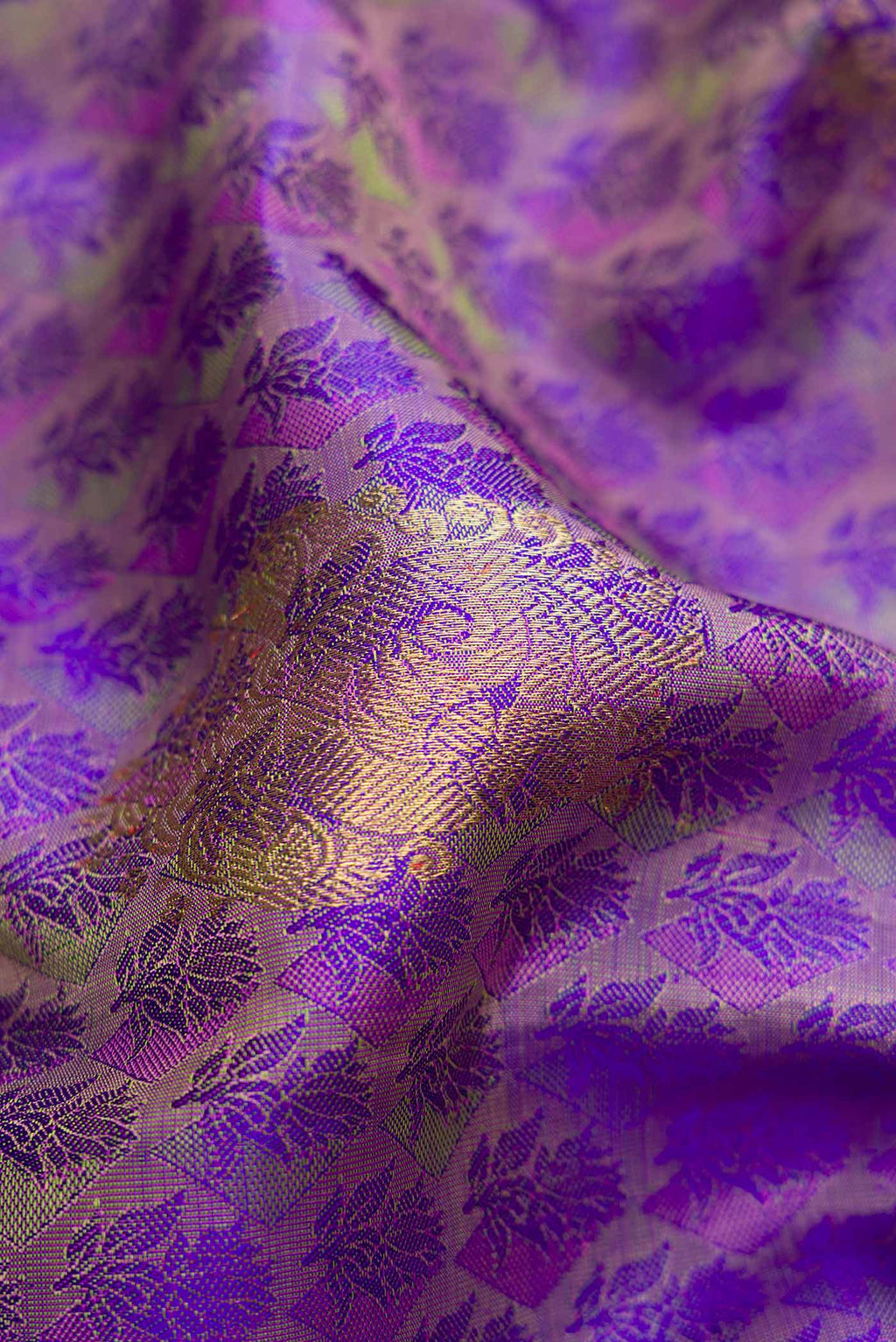 Close up of Pure Silk Pure Zari Purple Dual Tone Kanchipuram Saree with Jacquard With Zari Butta on the body and Zari Border.  displaying folds
