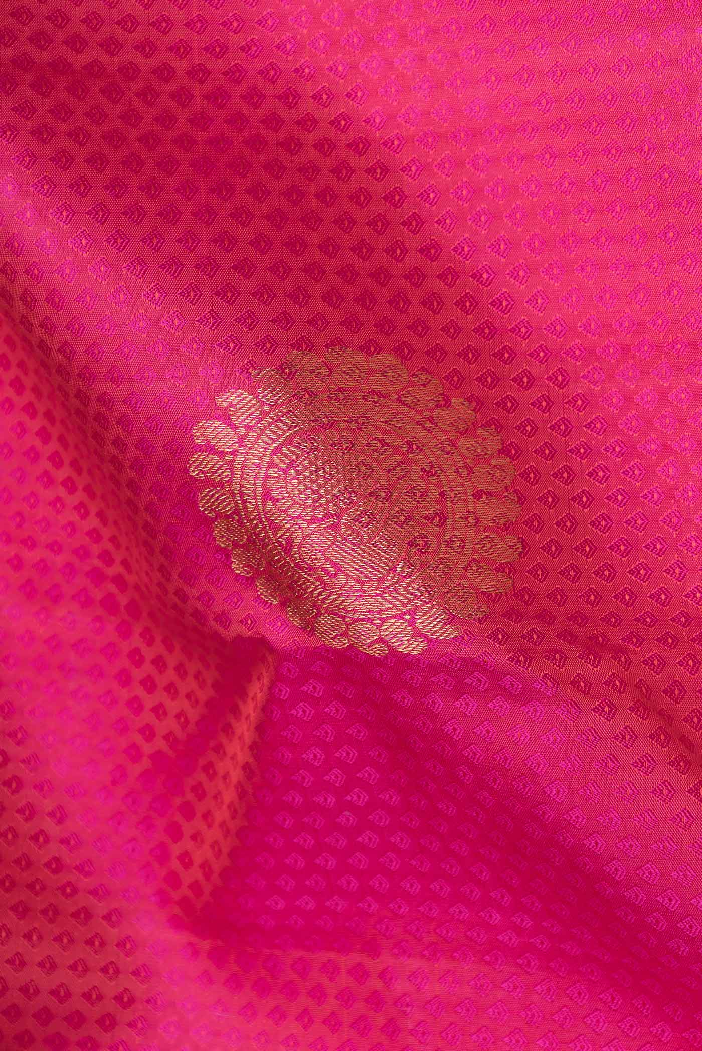 Close up of Pink Dual Tone Kanchipuram Saree with Jacquard With Zari Butta on the body and Zari Border displaying folds