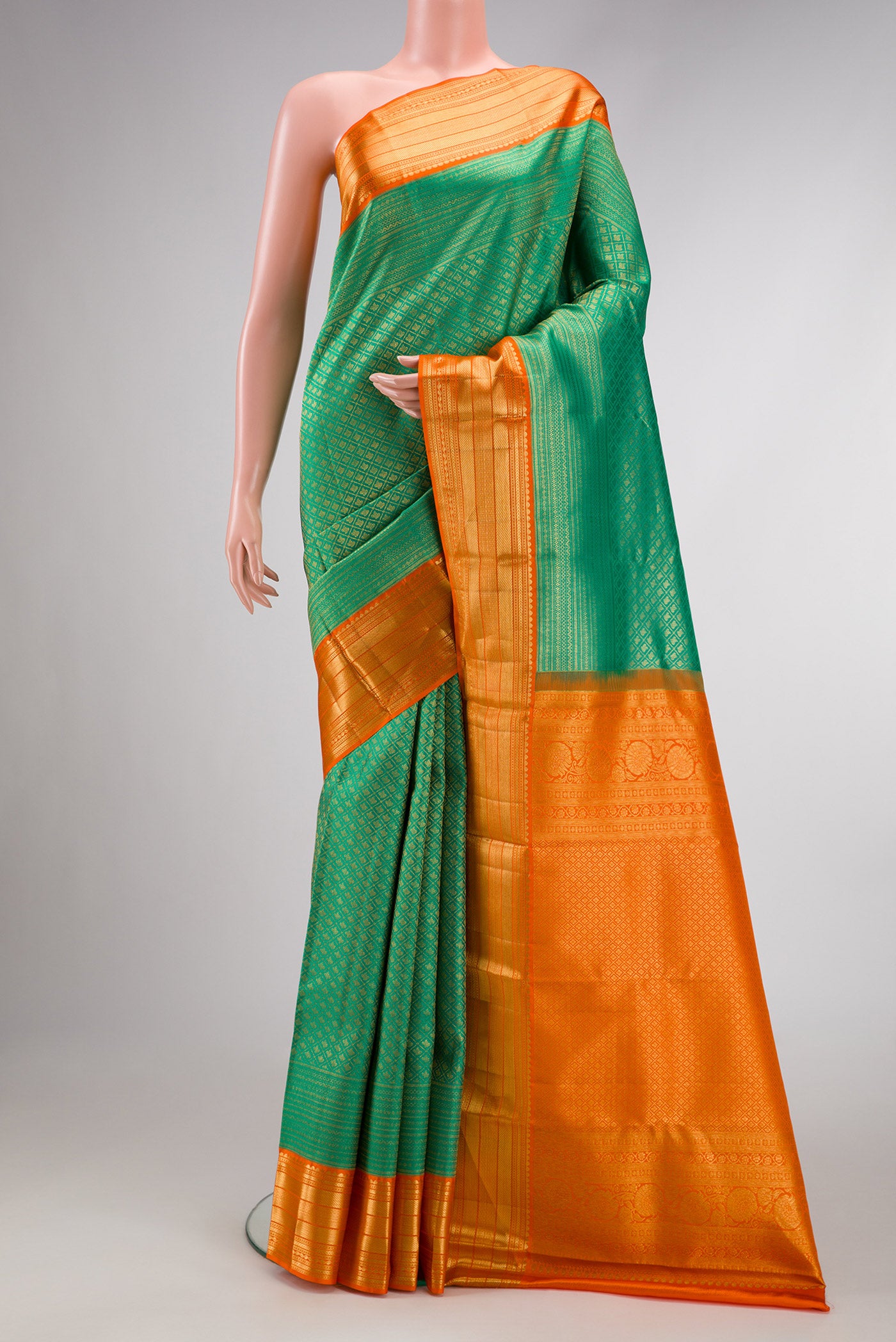 Green Dual Tone Kanchipuram Silk Saree with Zari Brocade on the body and Zari Border.  displayed on a mannequin