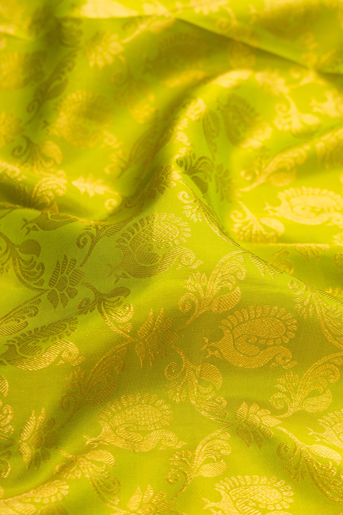 Close up of Green Dual Tone Kanchipuram Silk Saree with Zari Brocade on the body and Zari Border.  displaying folds