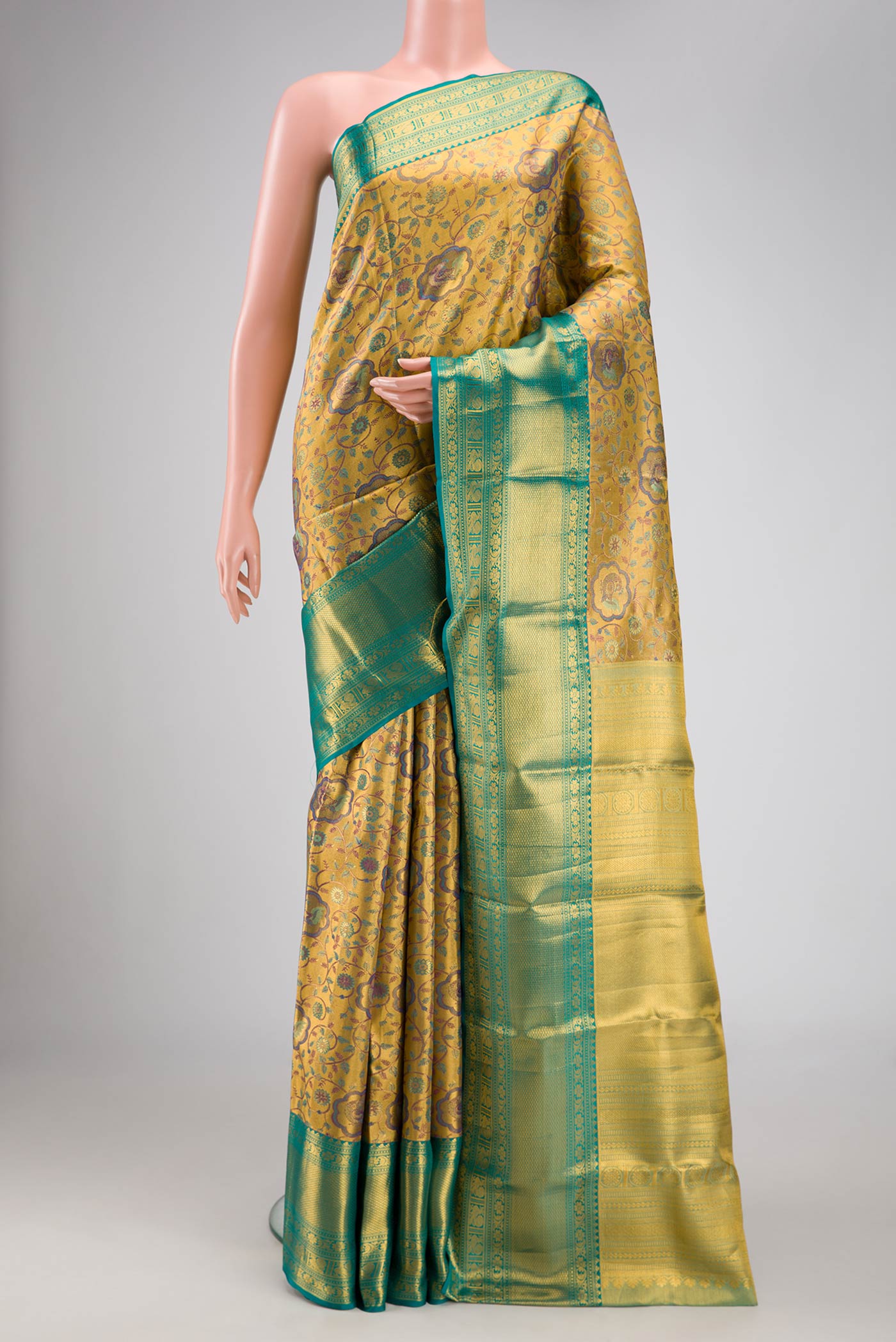 Gold Dual Tone Kanchipuram Tissue Silk Saree with Zari Brocade on the body and Zari Border.  displayed on a mannequin
