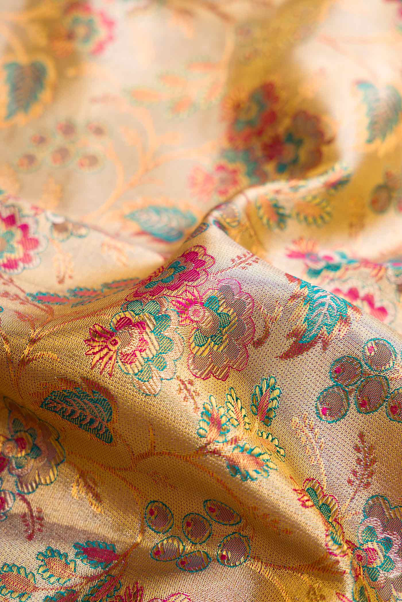 Close up of Gold Dual Tone Kanchipuram Tissue Silk Saree with Zari Brocade on the body and Zari Border.  displaying folds