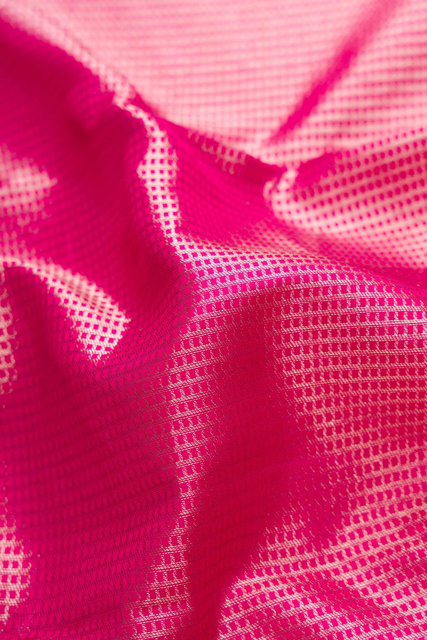 Close up of Pink Dual Tone Kanchipuram Saree with Zari Brocade on the body and Zari Border displaying folds