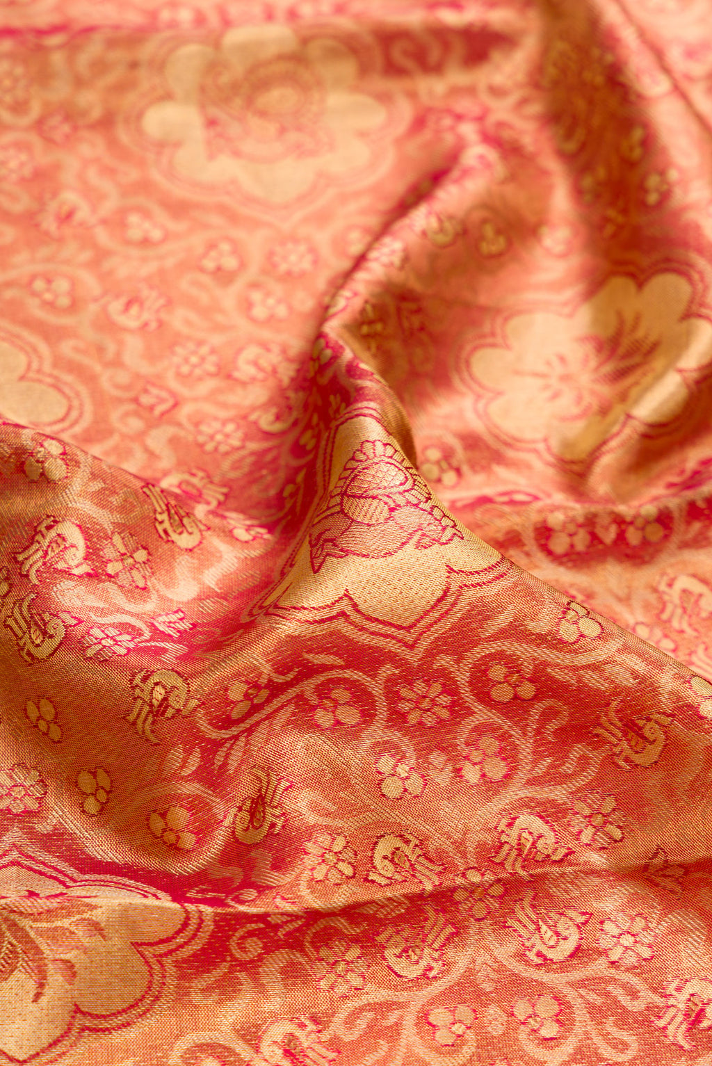 Close up of Pink Dual Tone Kanchipuram Tissue Silk Saree with Zari Brocade on the body and Zari Border.  displaying folds