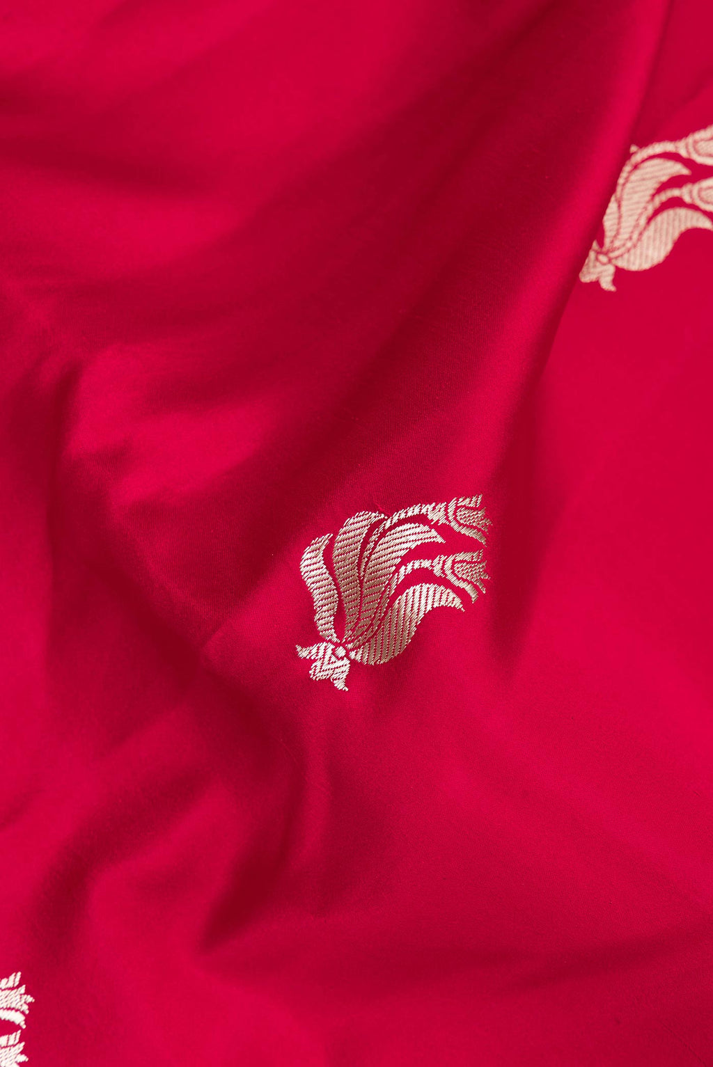 Close up of Pure Silk Red Banarasi Saree with Zari Butta on the body and Zari Border.  displaying folds