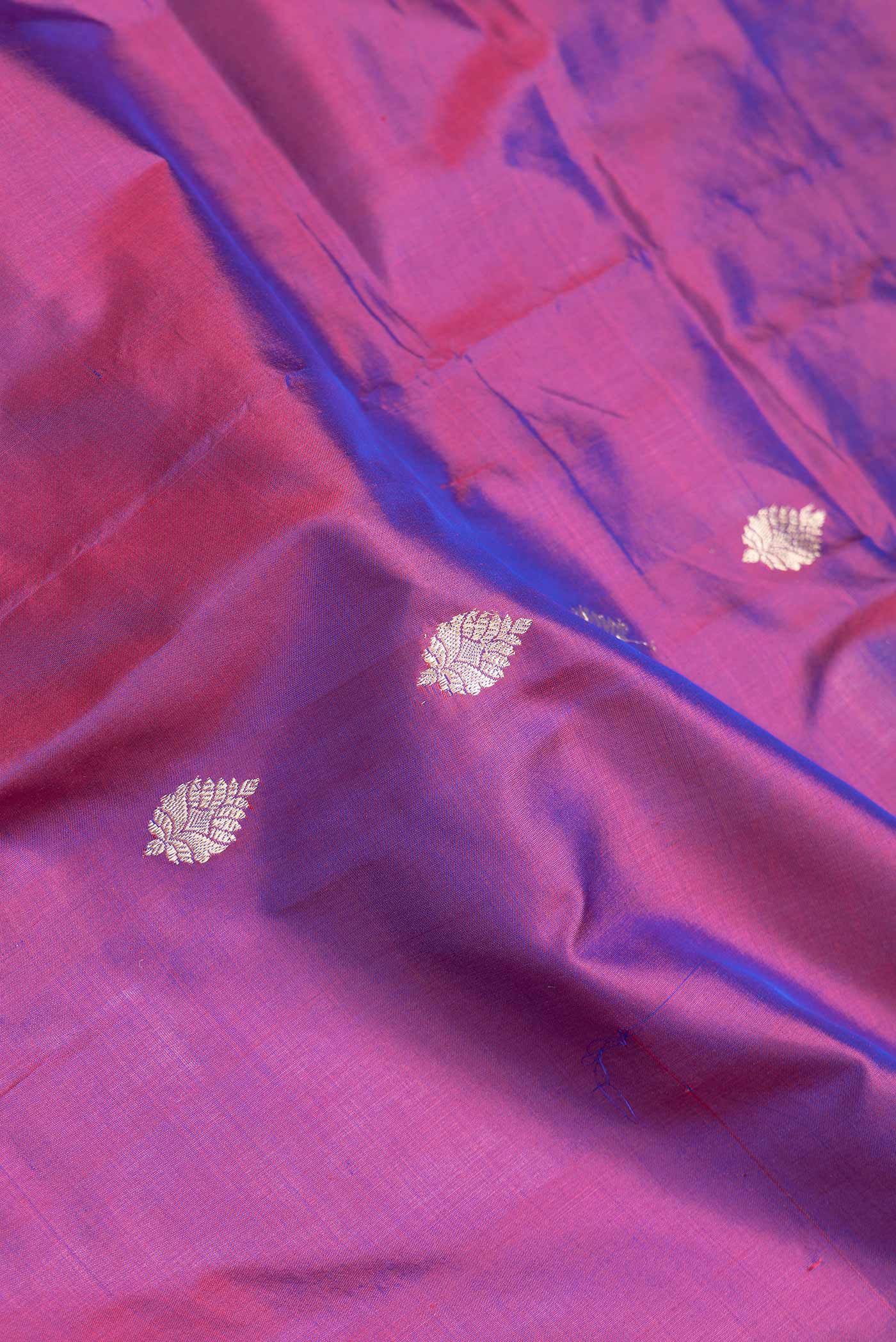 Close up of Purple Dual Tone Banarasi Silk Saree with Zari Butta on the body and Zari Border.  displaying folds