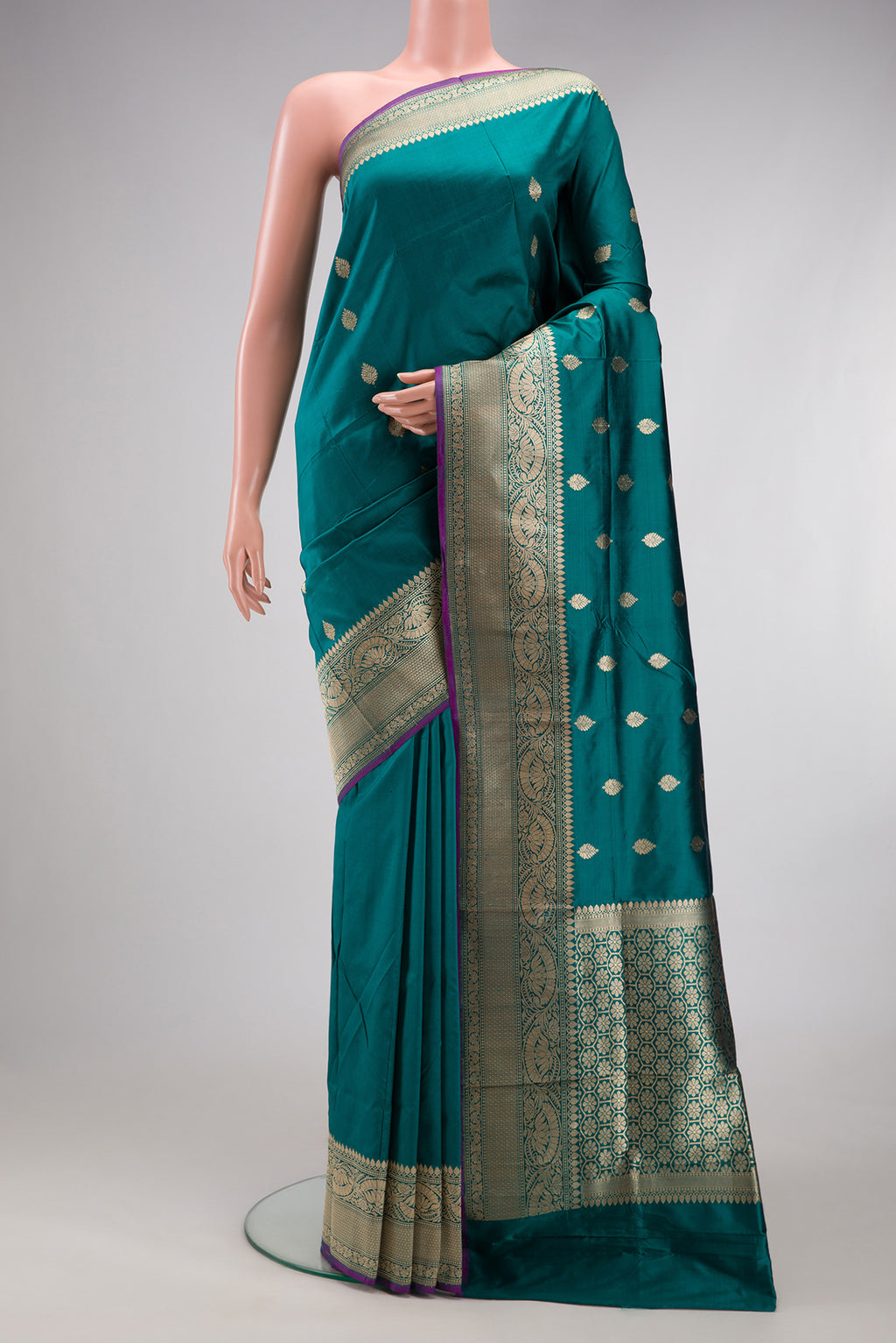 Peacock Blue Banarasi Silk Saree with Zari Butta on the body and Fancy Border.  displayed on a mannequin