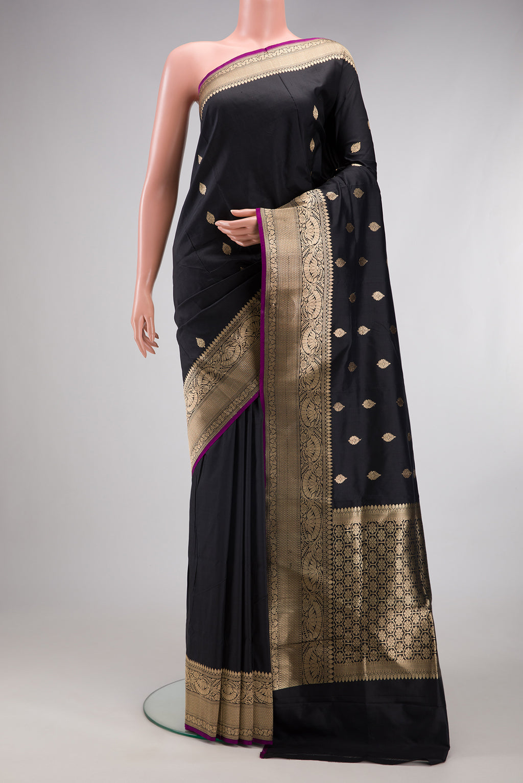 Black Banarasi Silk Saree with Zari Butta on the body and Fancy Border.  displayed on a mannequin