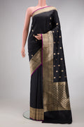 Black Banarasi Silk Saree with Zari Butta on the body and Fancy Border.  displayed on a mannequin