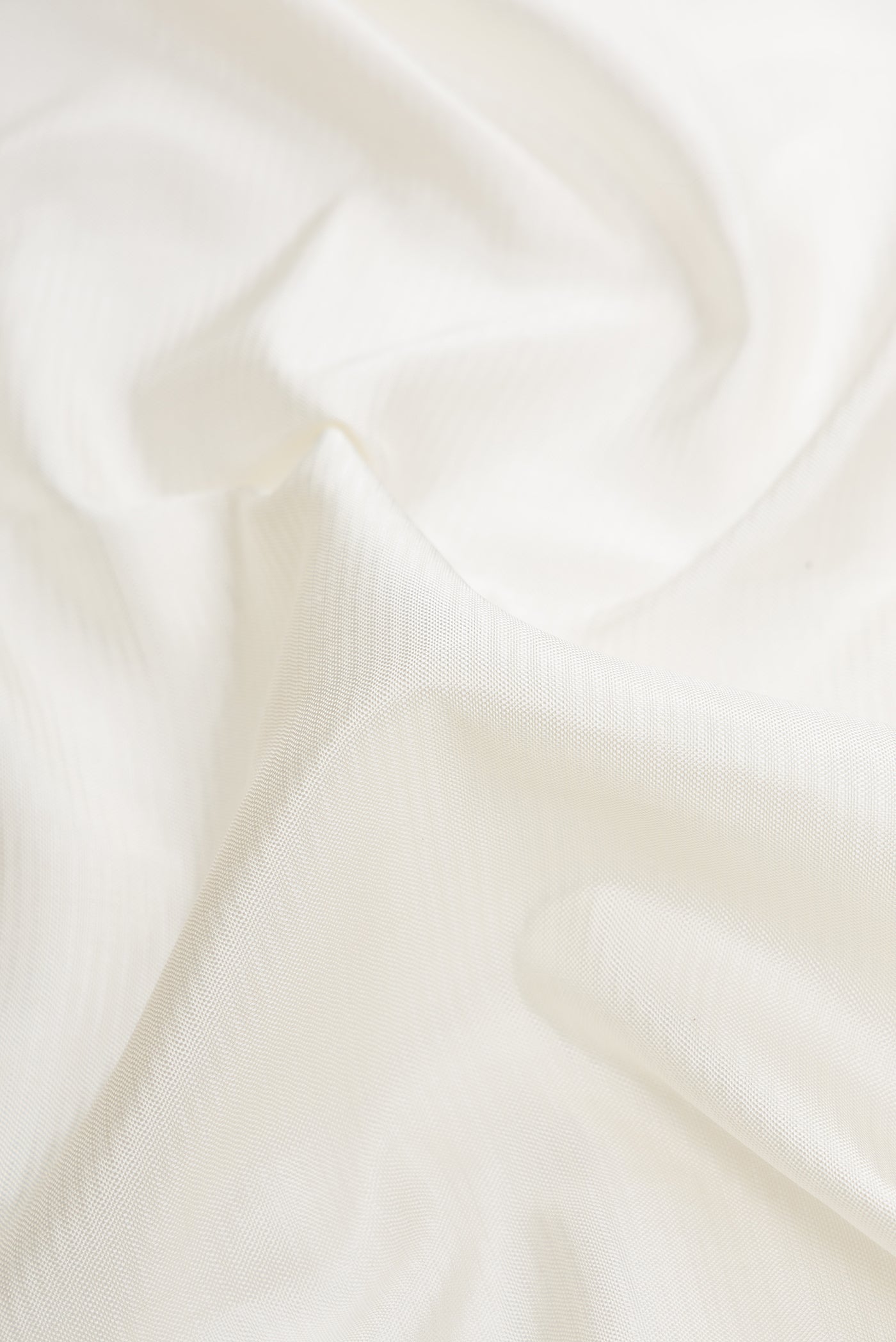 Close up of Off White Dual Tone Double Ikat Saree with Stripes on the body and Ikat Border.  displaying folds