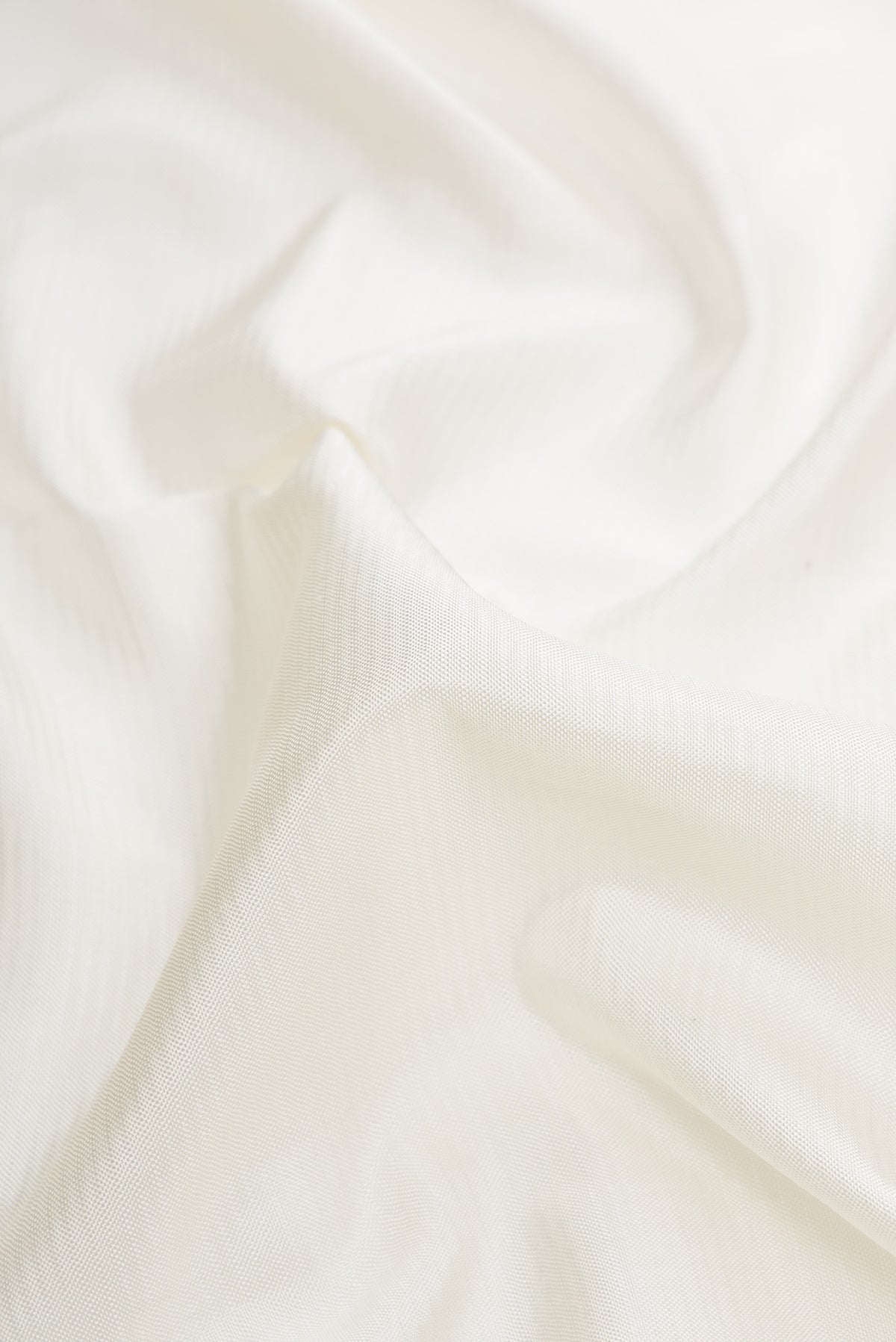 Close up of Off White Dual Tone Double Ikat Saree with Stripes on the body and Ikat Border.  displaying folds