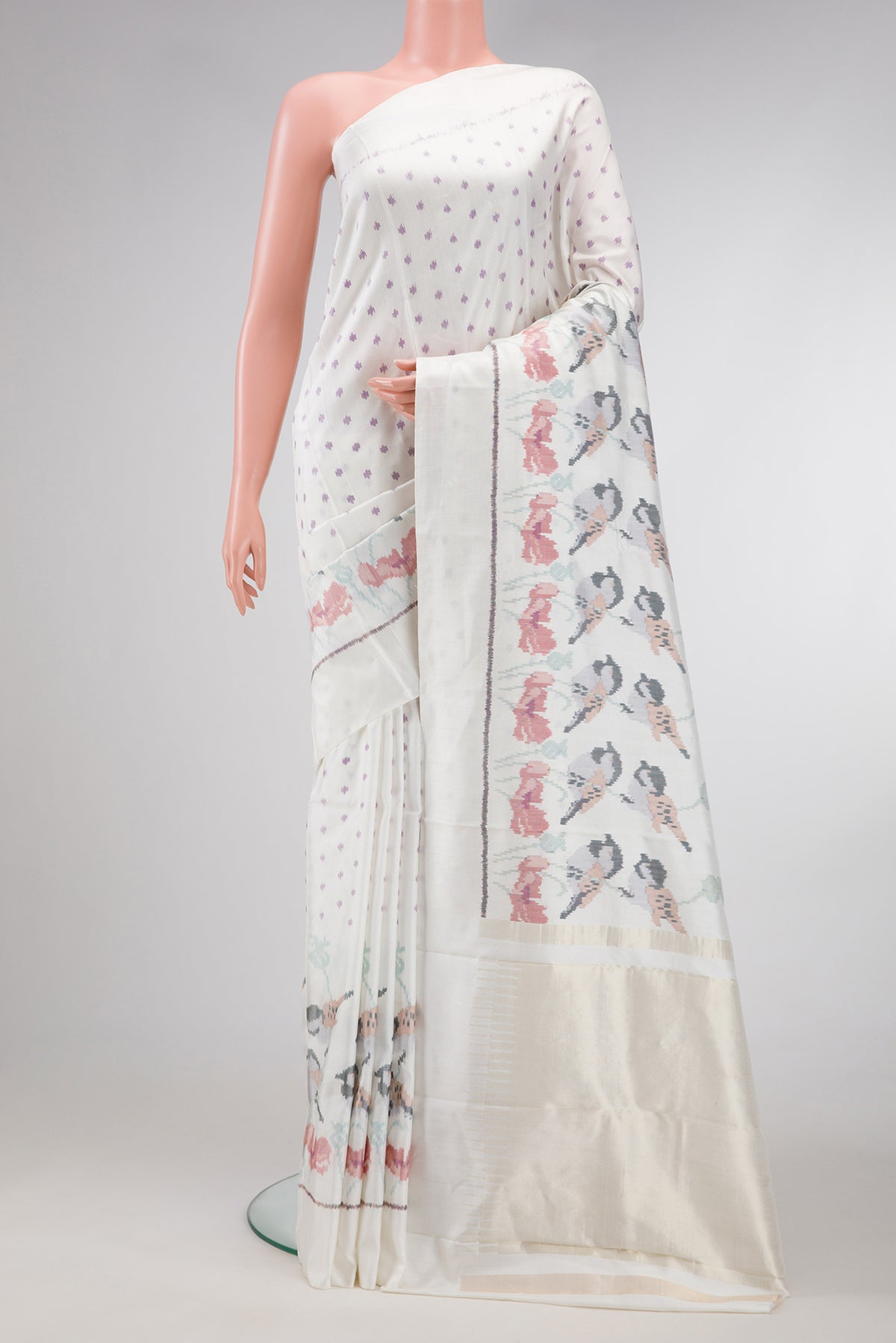 White Dual Tone Rajkot Patola Silk Saree with Ikat Print on the body and Ikat Border.  displayed on a mannequin