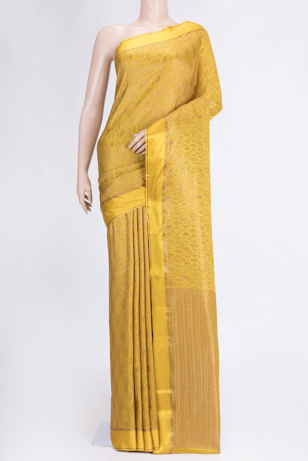 Mustard Dual Tone Mysore Crepe Saree with Zari Brocade on the body and Zari And Thread Border.  displayed on a mannequin
