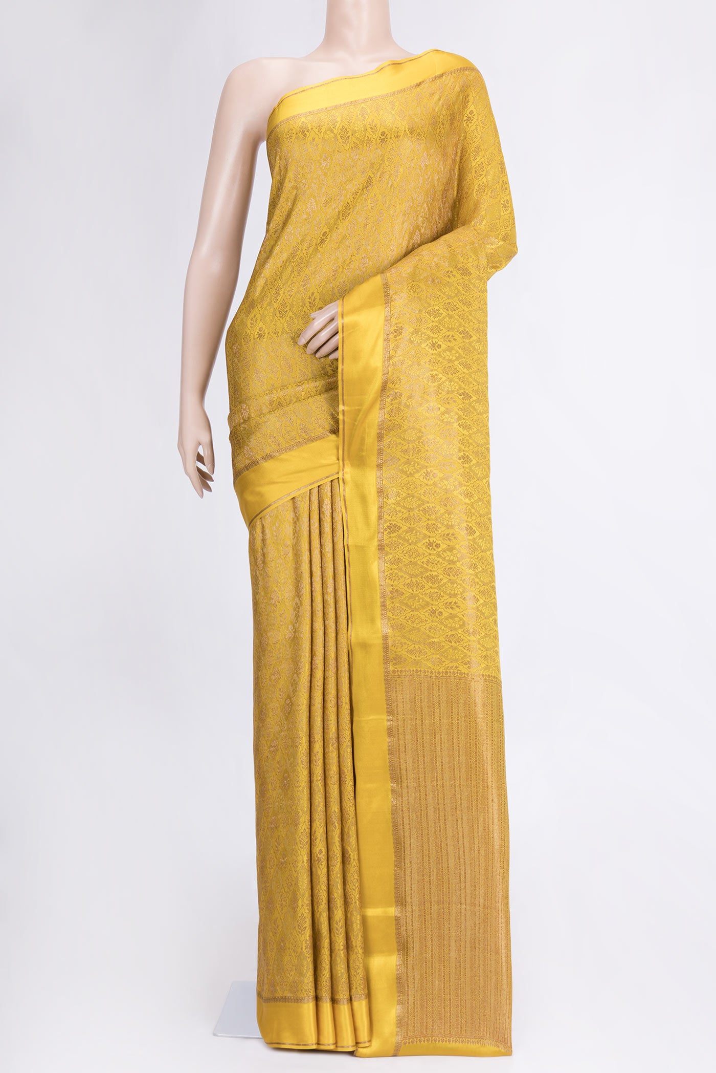 Mustard Dual Tone Mysore Crepe Saree with Zari Brocade on the body and Zari And Thread Border.  displayed on a mannequin