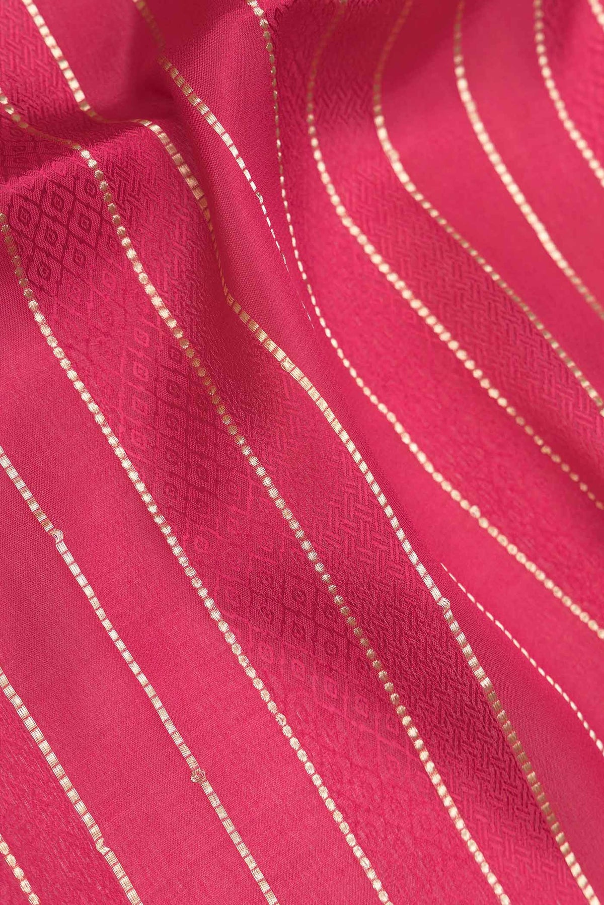 Close up of Dark Pink Dual Tone Mysore Crepe Saree with Stripes on the body and Zari Border displaying folds