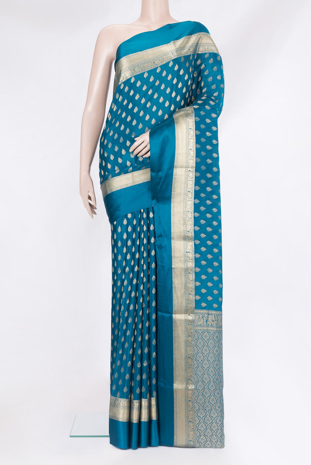 Peacock Blue Mysore Crepe Saree with Zari Butta on the body and Zari Border.  displayed on a mannequin