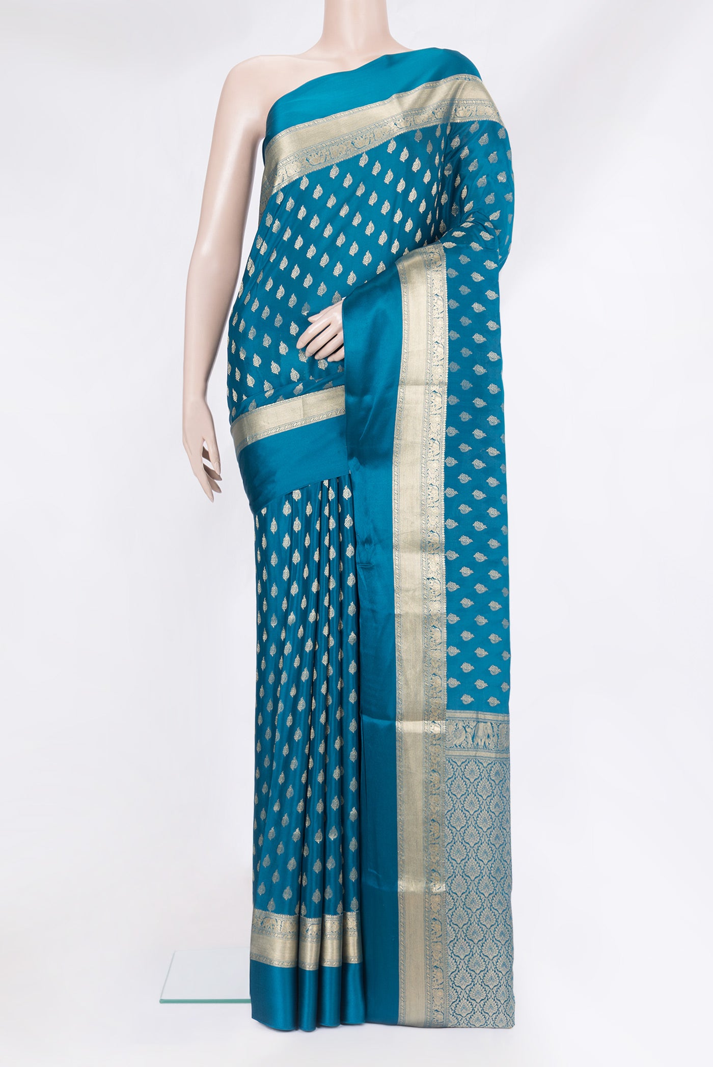 Peacock Blue Mysore Crepe Saree with Zari Butta on the body and Zari Border.  displayed on a mannequin
