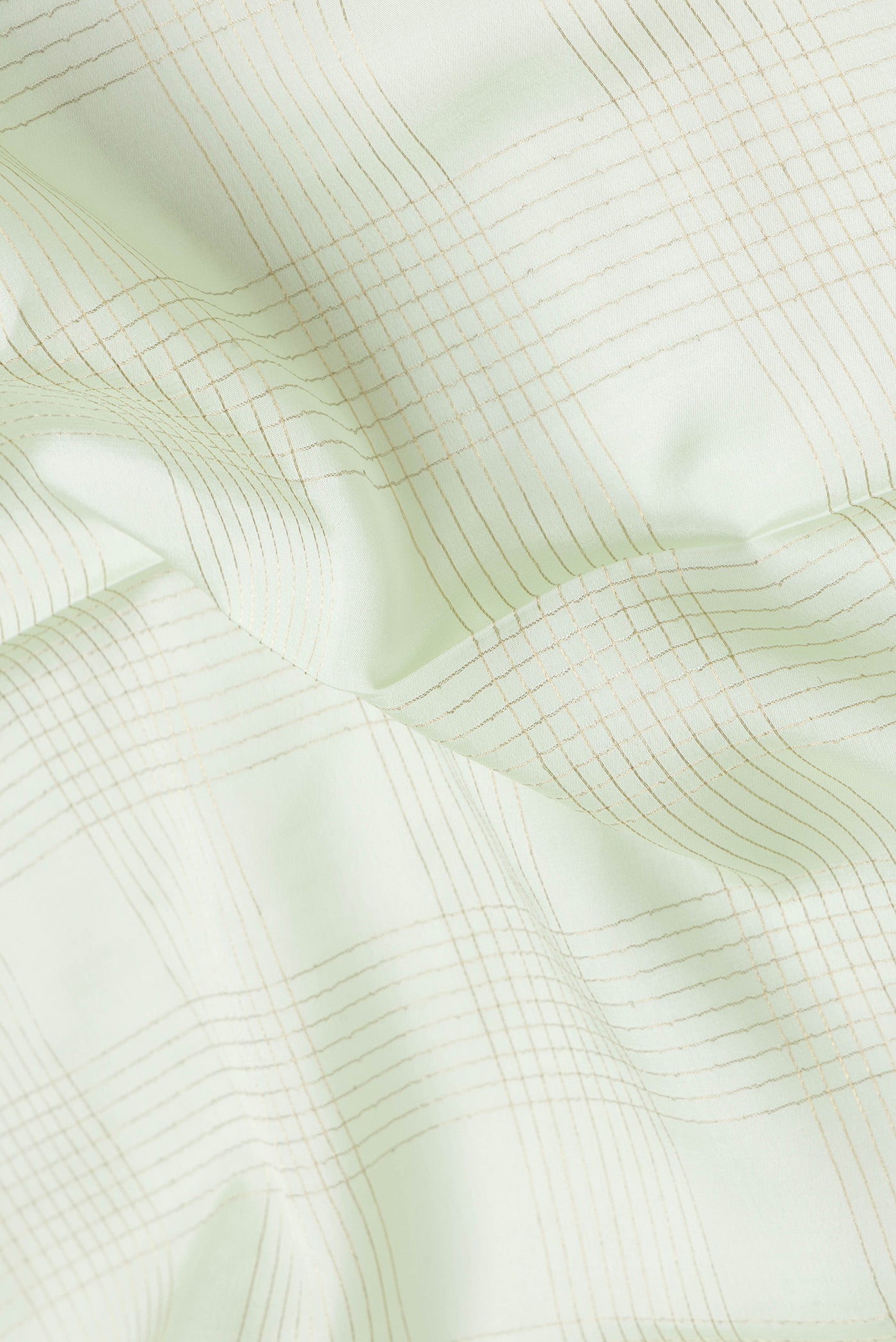 Close up of Pista Green Dual Tone Mysore Silk Saree with Checked design on the body and Zari And Thread Border.  displaying folds