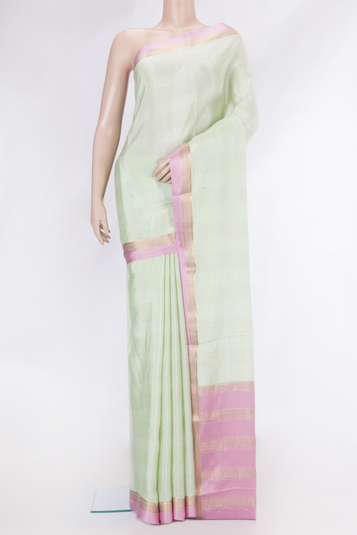 Pista Green Dual Tone Mysore Silk Saree with Checked design on the body and Zari And Thread Border.  displayed on a mannequin