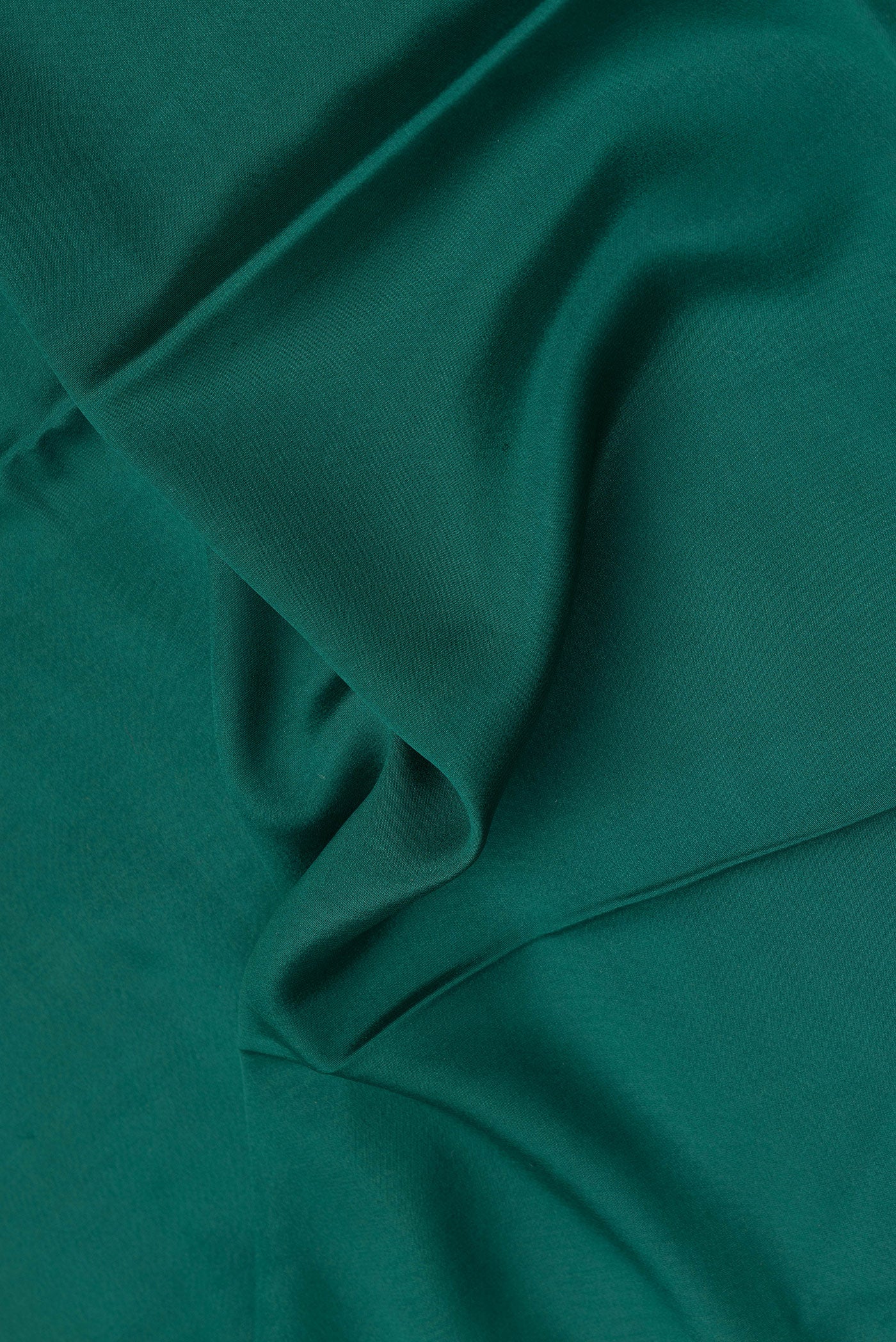 Close up of Bottle Green Dual Tone Mysore Crepe Saree with Plain Body and Fancy Border.  displaying folds