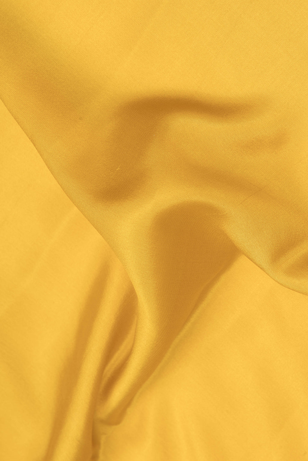 Close up of Mustard Mysore Crepe Saree with Plain Body and Fancy Border.  displaying folds