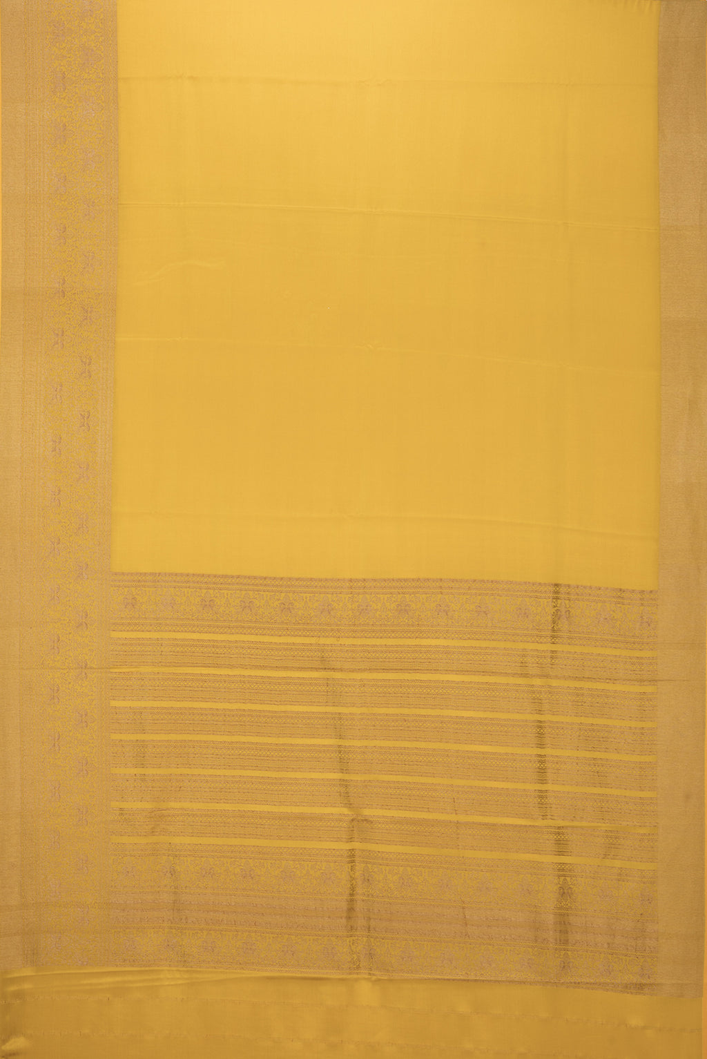 Flat view of Mustard Mysore Crepe Saree with Plain Body and Fancy Border. 