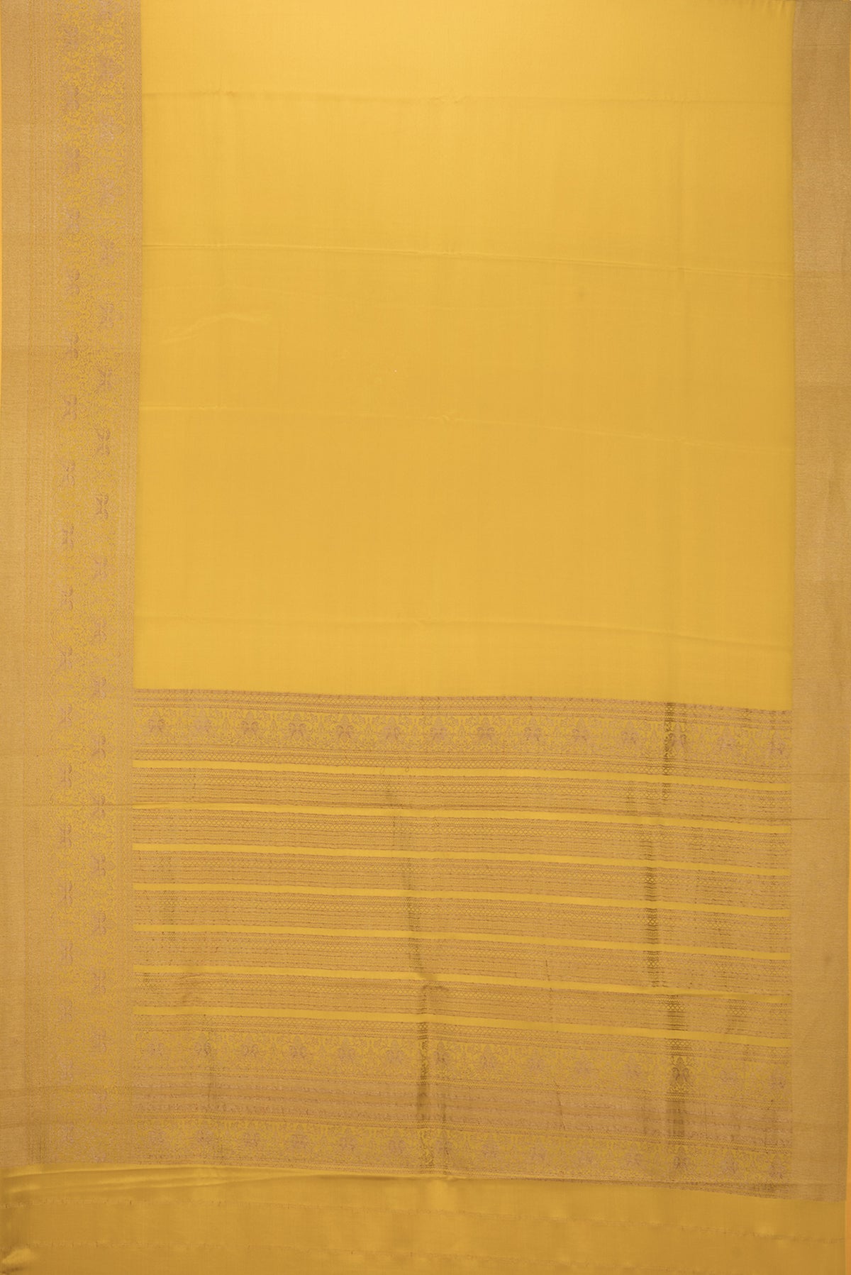 Flat view of Mustard Mysore Crepe Saree with Plain Body and Fancy Border. 