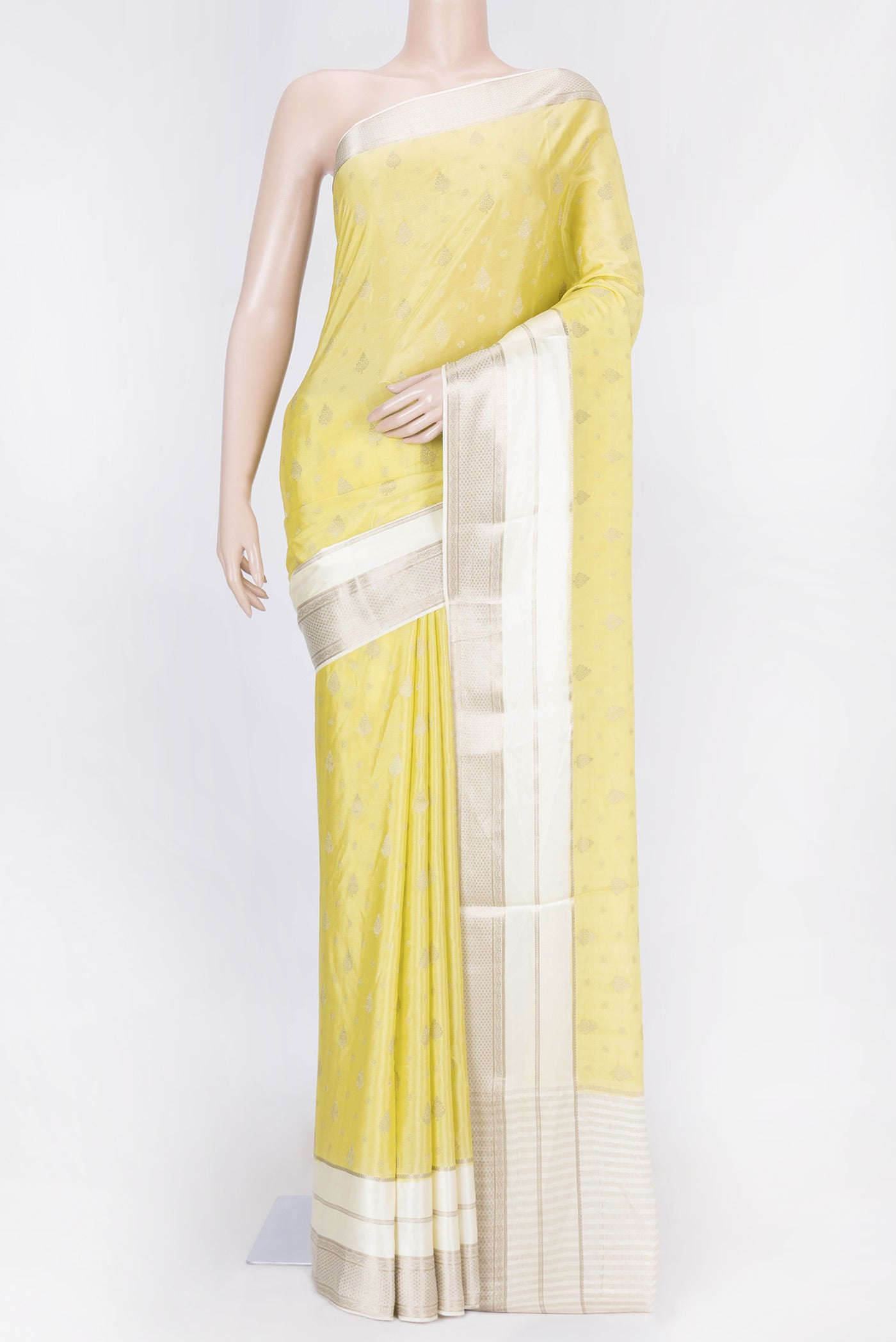 Lemon Yellow Dual Tone Tussar Silk Saree with Zari Butta on the body and Zari Border displayed on a mannequin