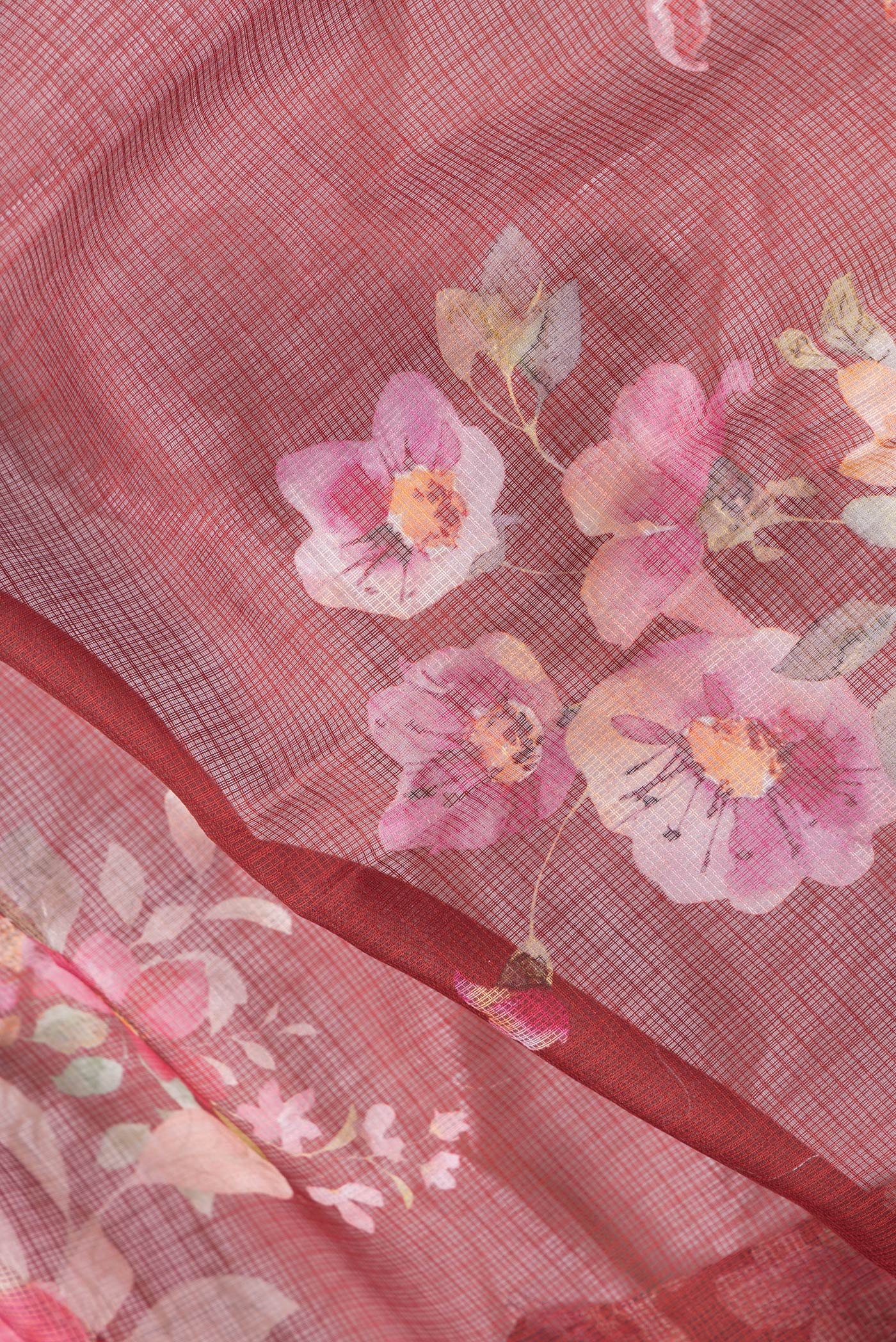 Close up of Red Dual Tone Kota Silk Saree with Printed design on the body and Thread Border.  displaying folds