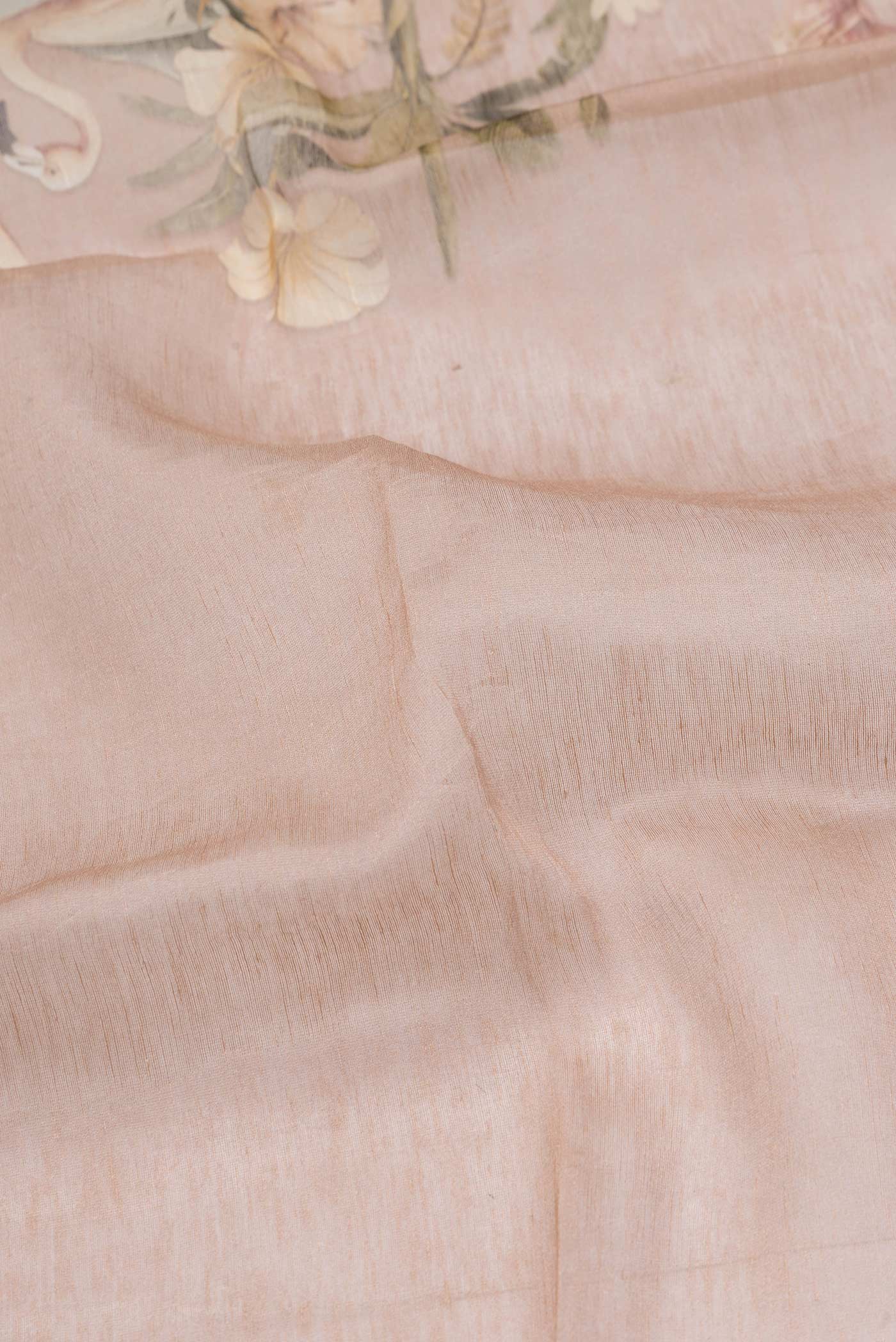 Close up of Golden Peach Dual Tone Linen Saree with Printed design on the body and Plain Border.  displaying folds