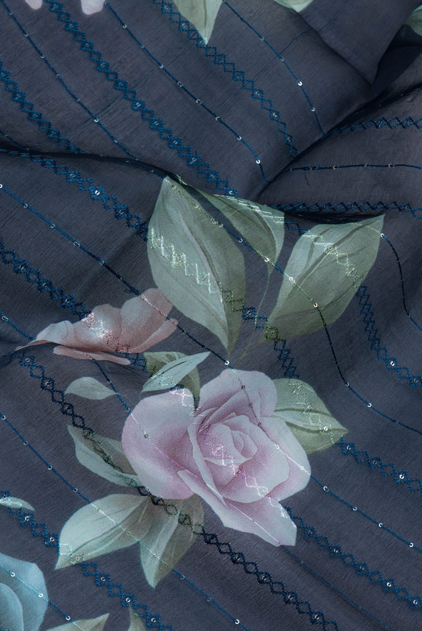 Close up of Navy Blue Organza Silk Saree with Embroidery on the body and Embroidery Border.  displaying folds
